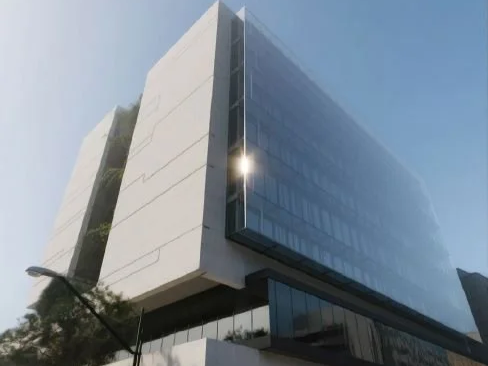 Commercial office architecture showcasing contemporary façade design, expansive glazing, and a refined urban presence.
