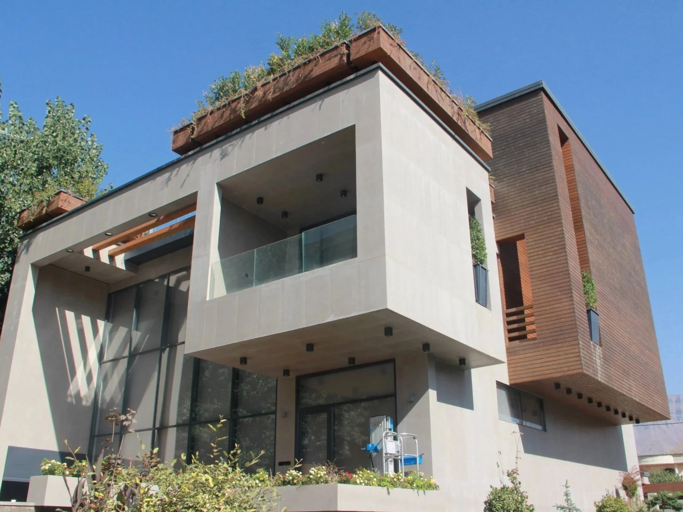 Luxury custom residence with contemporary architectural design, generous glazing, rooftop terrace, and refined material palette.