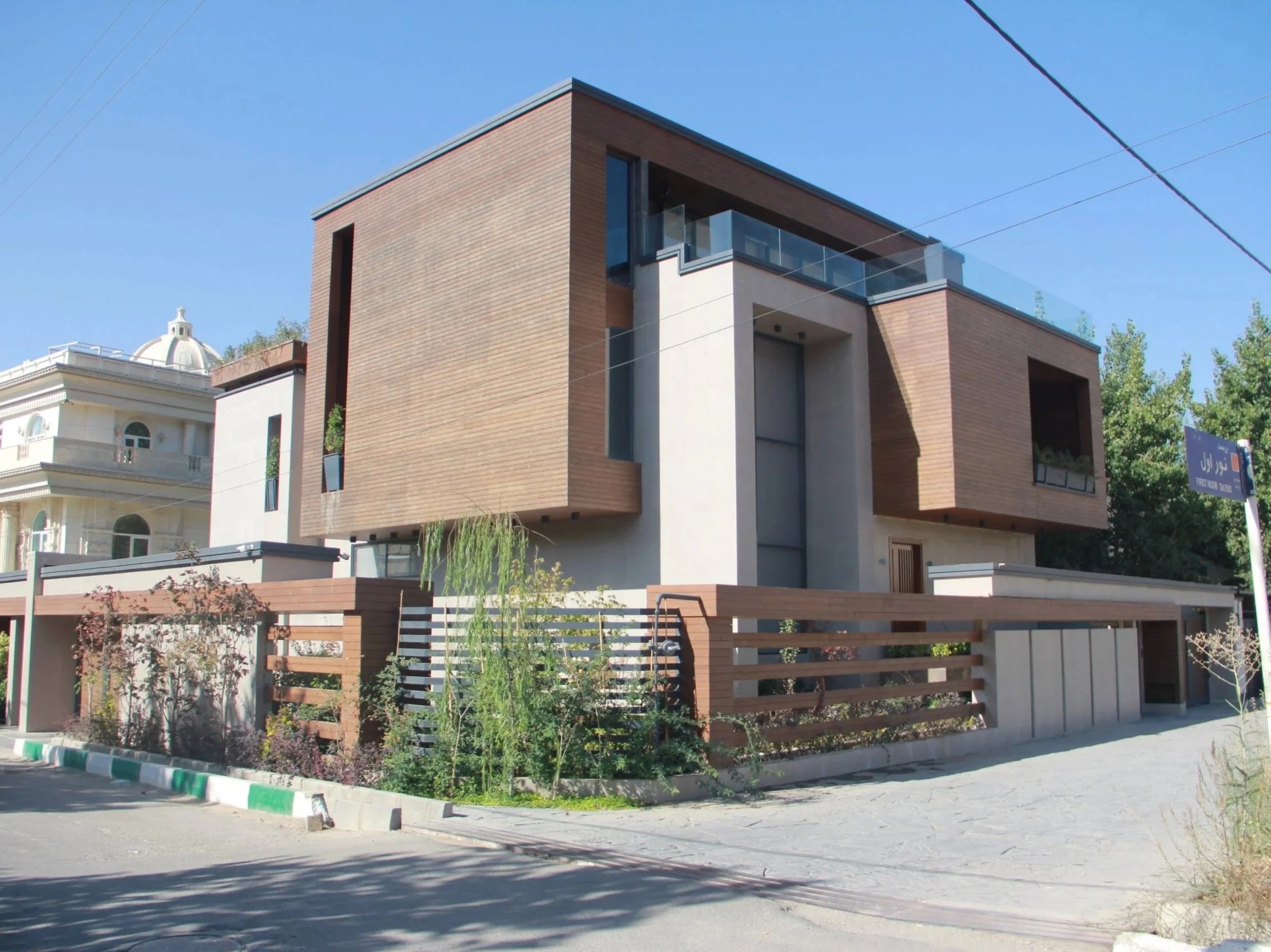 Modern custom residence with wood cladding, large glazing, and minimalist architectural design.
