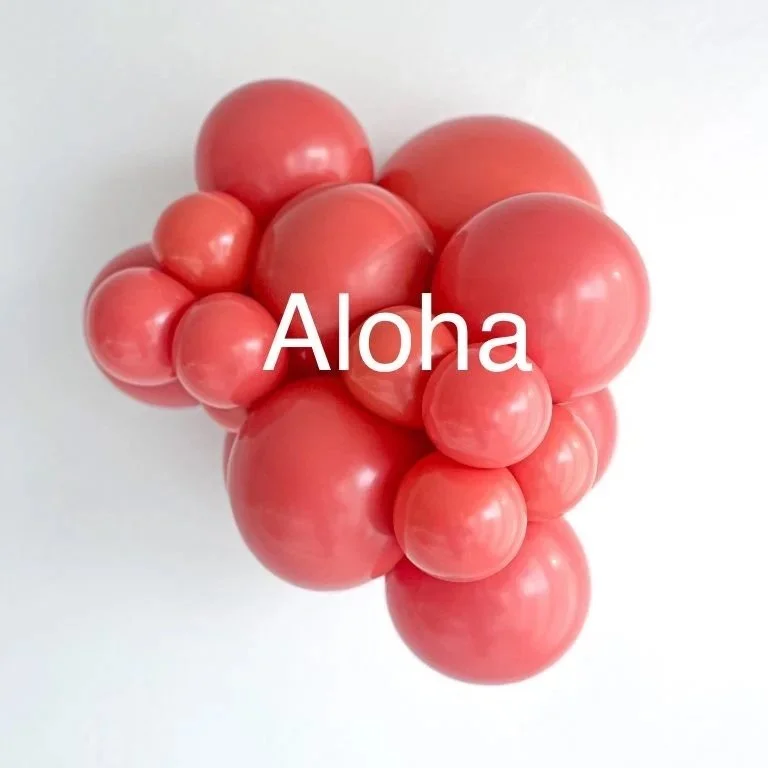 Arrangement of pink spherical objects resembling a bunch of grapes with the word 'Aloha' overlayed.