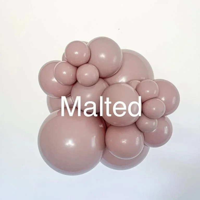 A cluster of pinkish-beige plastic bubbles resembling molecules or abstract art with the word 'Malted' overlaid.