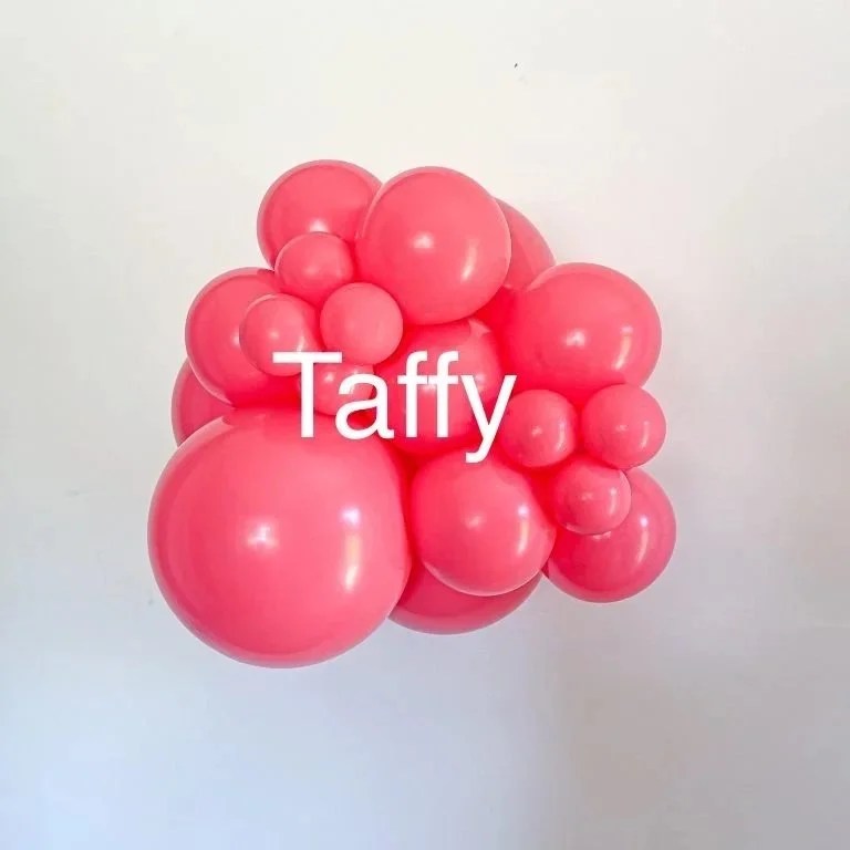 Pink balloons clustered together with the word "Taffy" overlayed in the center.