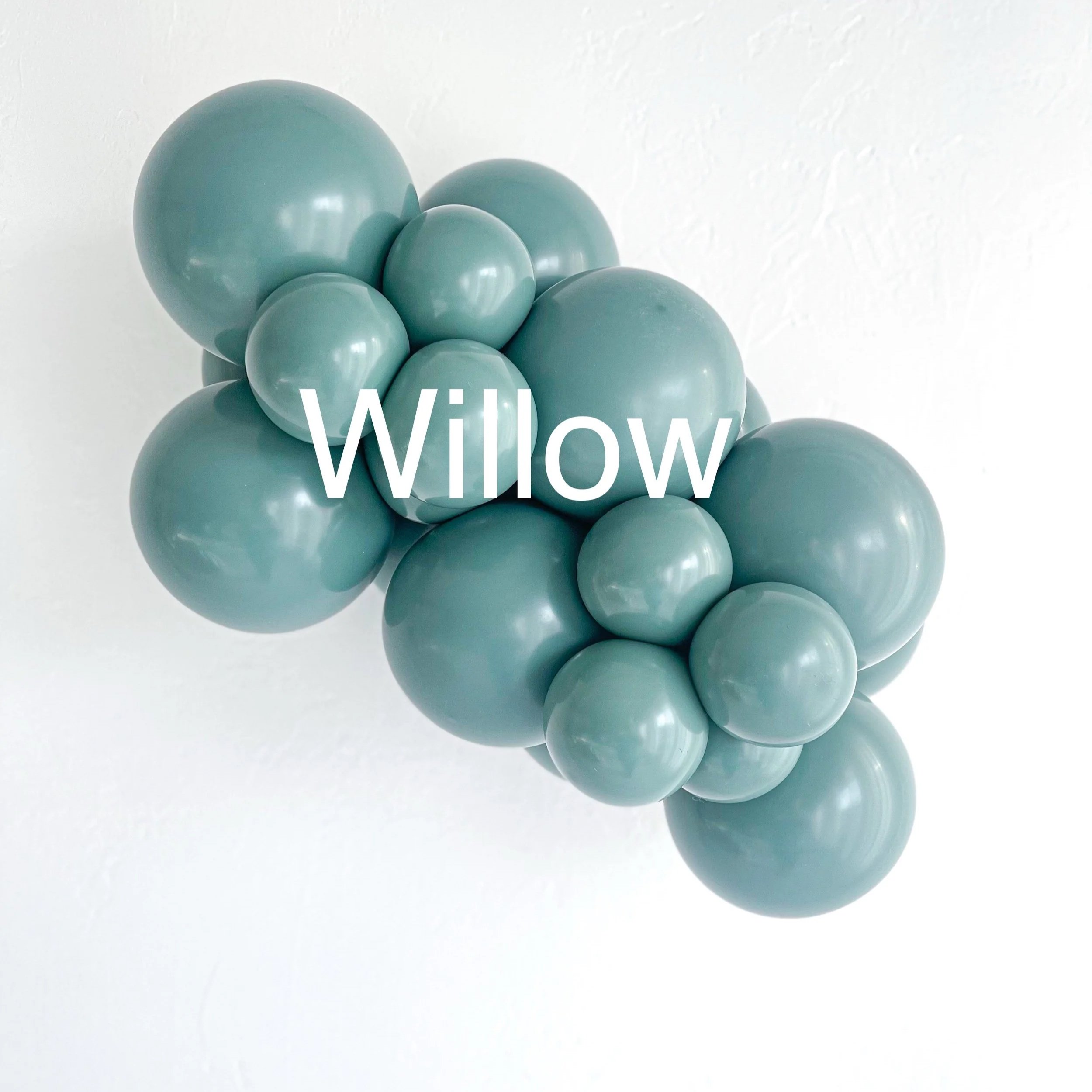 A cluster of light green rubber balls stacked together against a white background with the word 'Willow' written on them.
