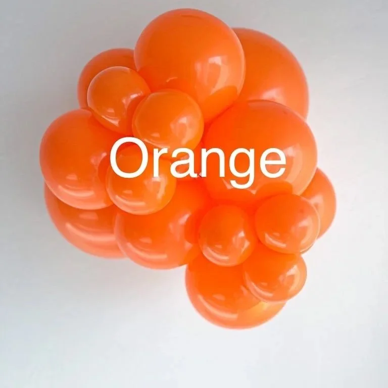 Group of orange rubber balls and the word 'Orange' written over them.