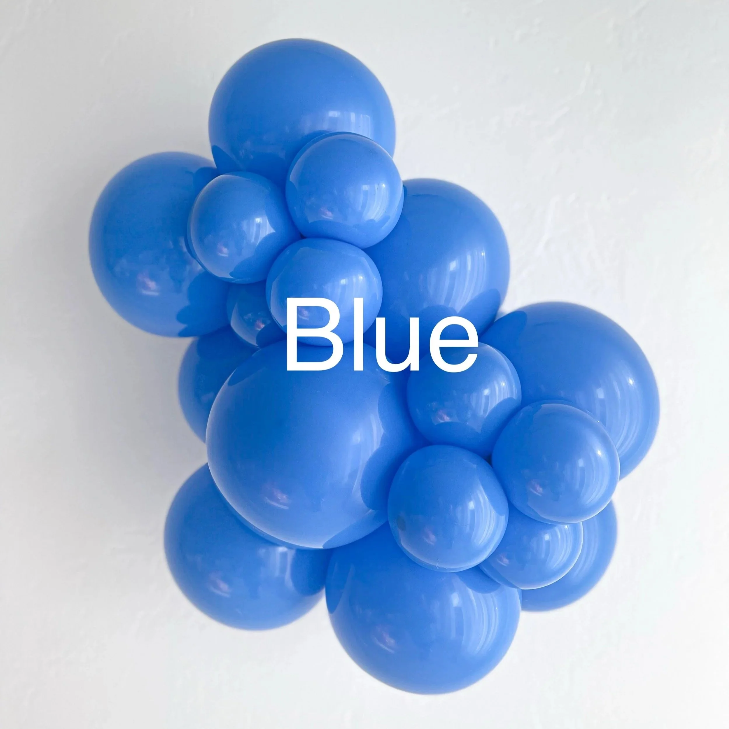 Group of blue plastic balls arranged in a cluster with the words 'Blue' partially visible at the bottom.