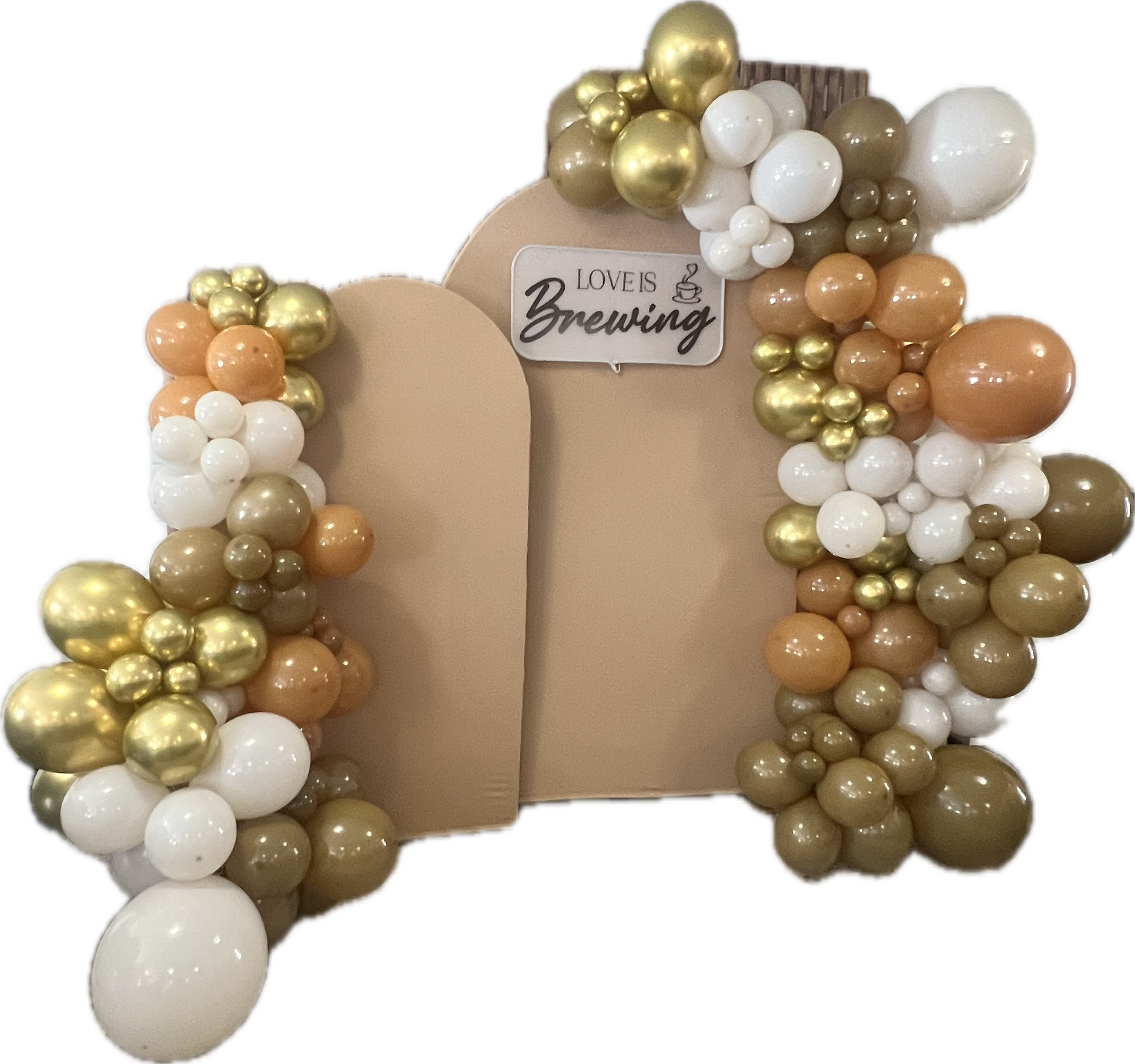 Decorative balloon arrangement with gold, white, peach, and beige balloons surrounding a sign that reads 'Love is Brewing' with a coffee cup icon.