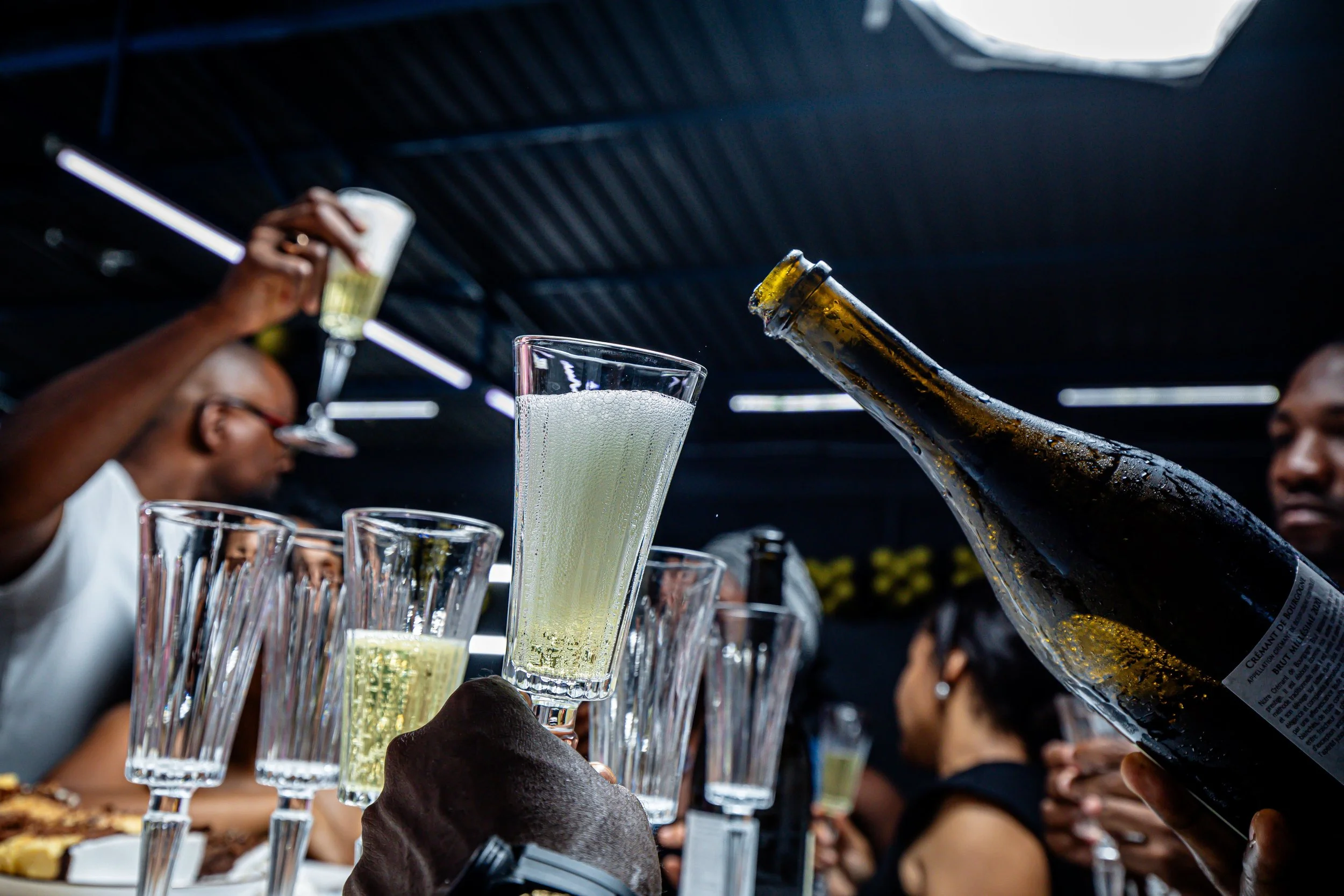 Group of black people drinking champagne and having a good time.