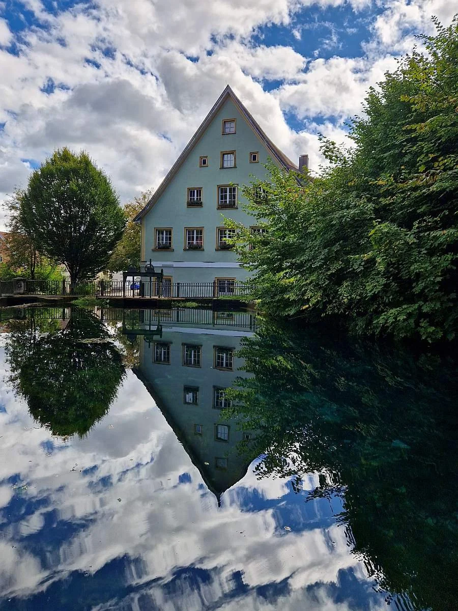 Haus gespiegelt in einer natürlichen Quelle