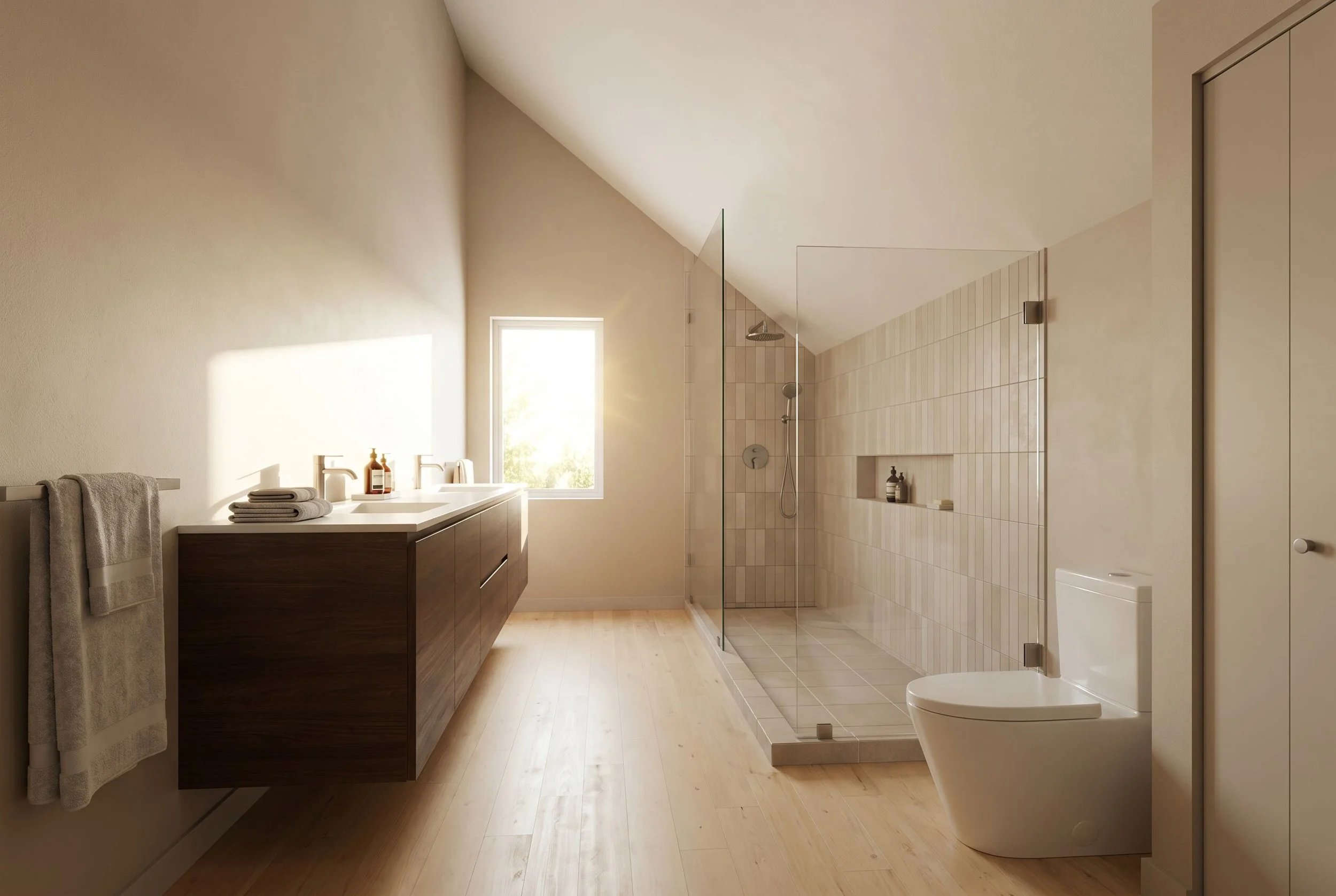 Modern bathroom with a sloped ceiling, a wooden vanity with towels, a window allowing natural light, a glass-enclosed shower with beige tiles, and a sleek toilet.