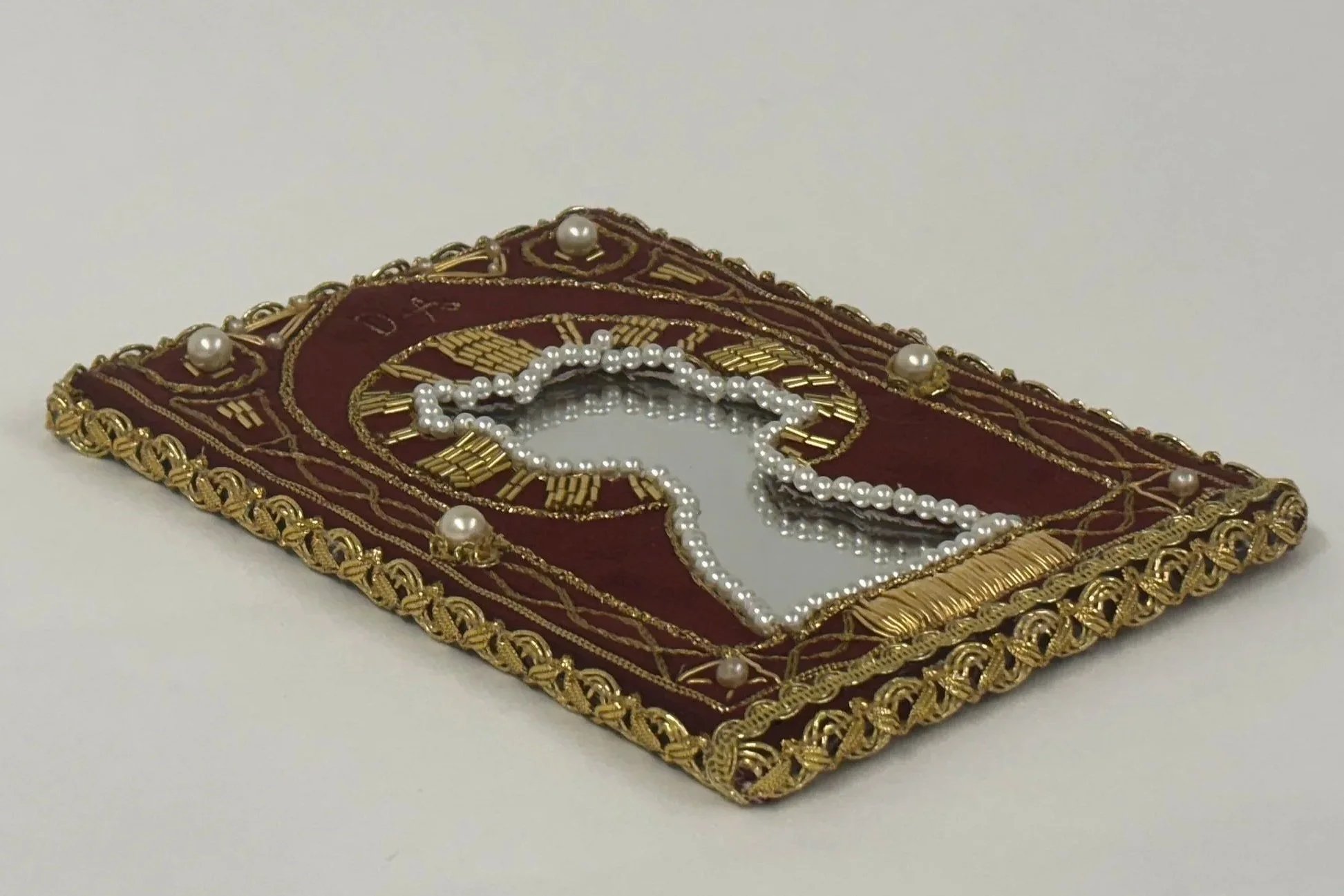 Alexis Fredericks, DEVOTION., embroidered textile icon inspired by Russian Orthodox devotional imagery, exploring cultural heritage, postmemory, adoption, and the search for belonging. Goldwork, beading.