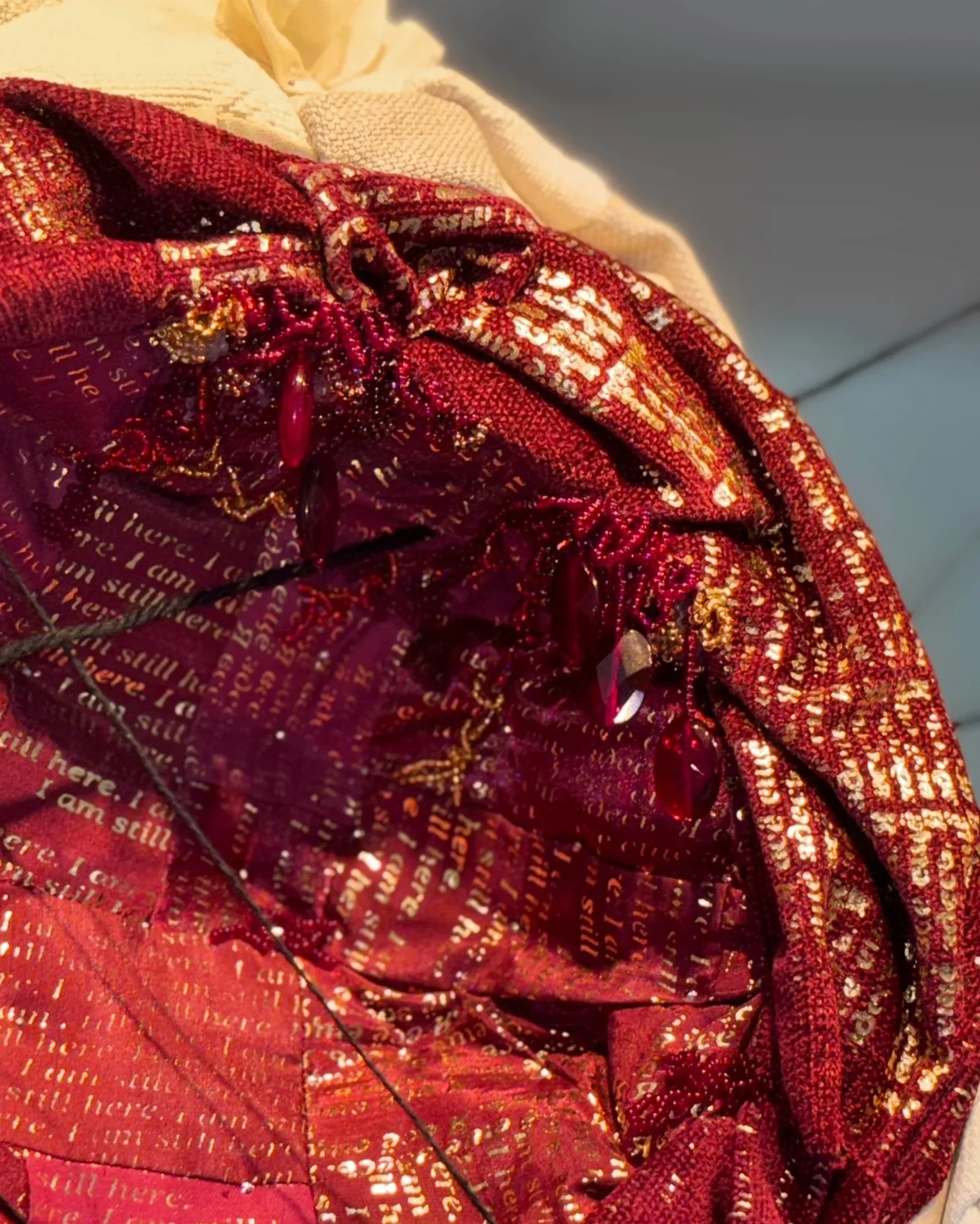Alexis Fredericks, I AM STILL HERE., participatory textile installation fostering an encounter between viewer and artwork, where meaning emerges through active engagement rather than passive observation. Detail.