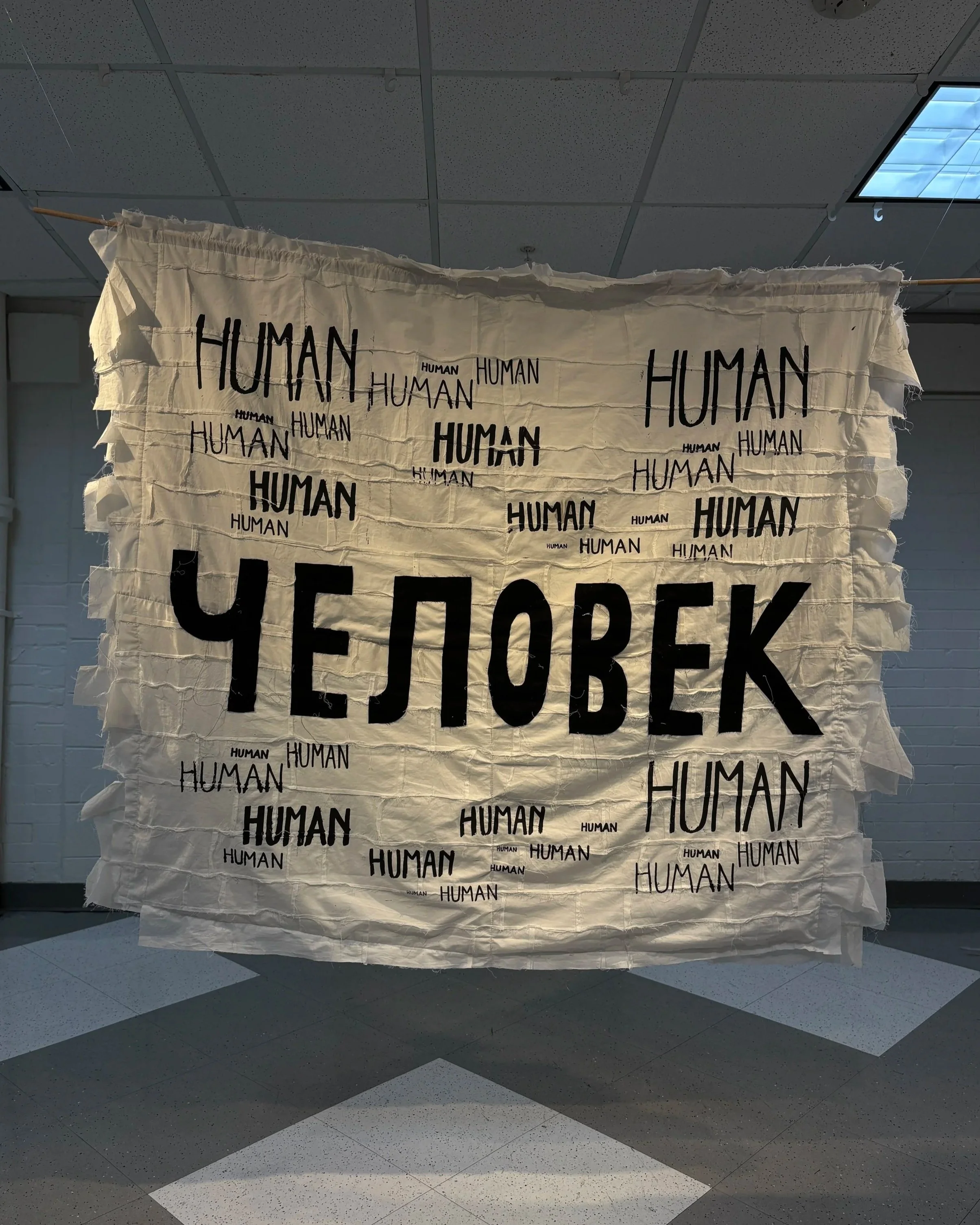 Alexis Fredericks, HUMAN., double-sided quilt installation examining memory, identity, and inherited histories through screen printing and appliqué. Side 2: Russian