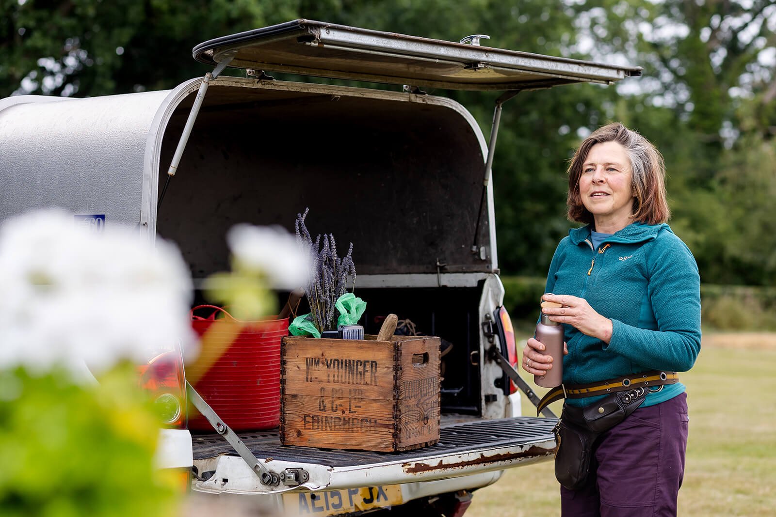 clare ryan standing beside her pickup full of gardening tools and equipment