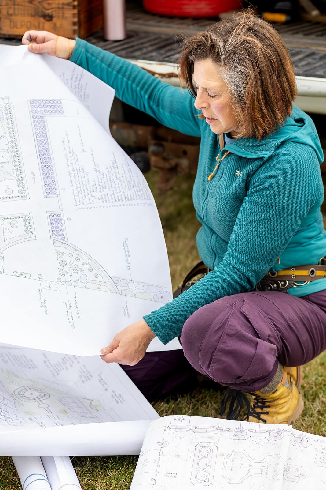 Clare Ryan Gardener Branding Photos with Clare Holding Plans