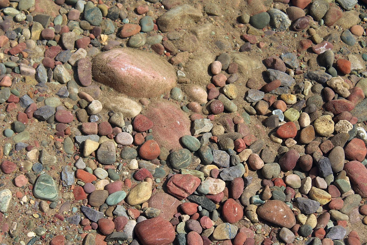 Clear Montana mountain spring water flowing over colorful natural stones.