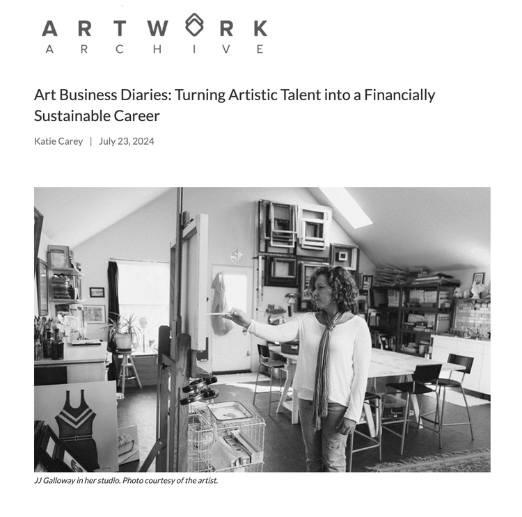 A woman stands in her art studio painting on a canvas with an easel, surrounded by art supplies and framed artwork on the walls.