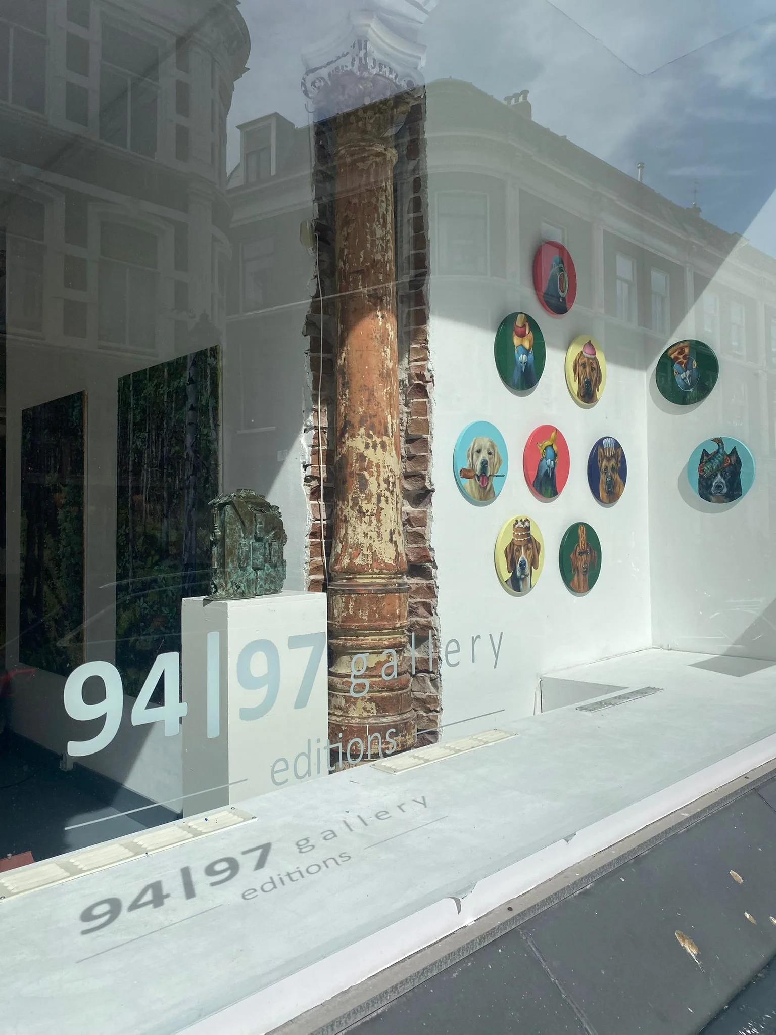 Artworks by JJ Galloway in a historic building in Amsterdam featured in the front window of an art gallery, 94|97 Art Gallery.