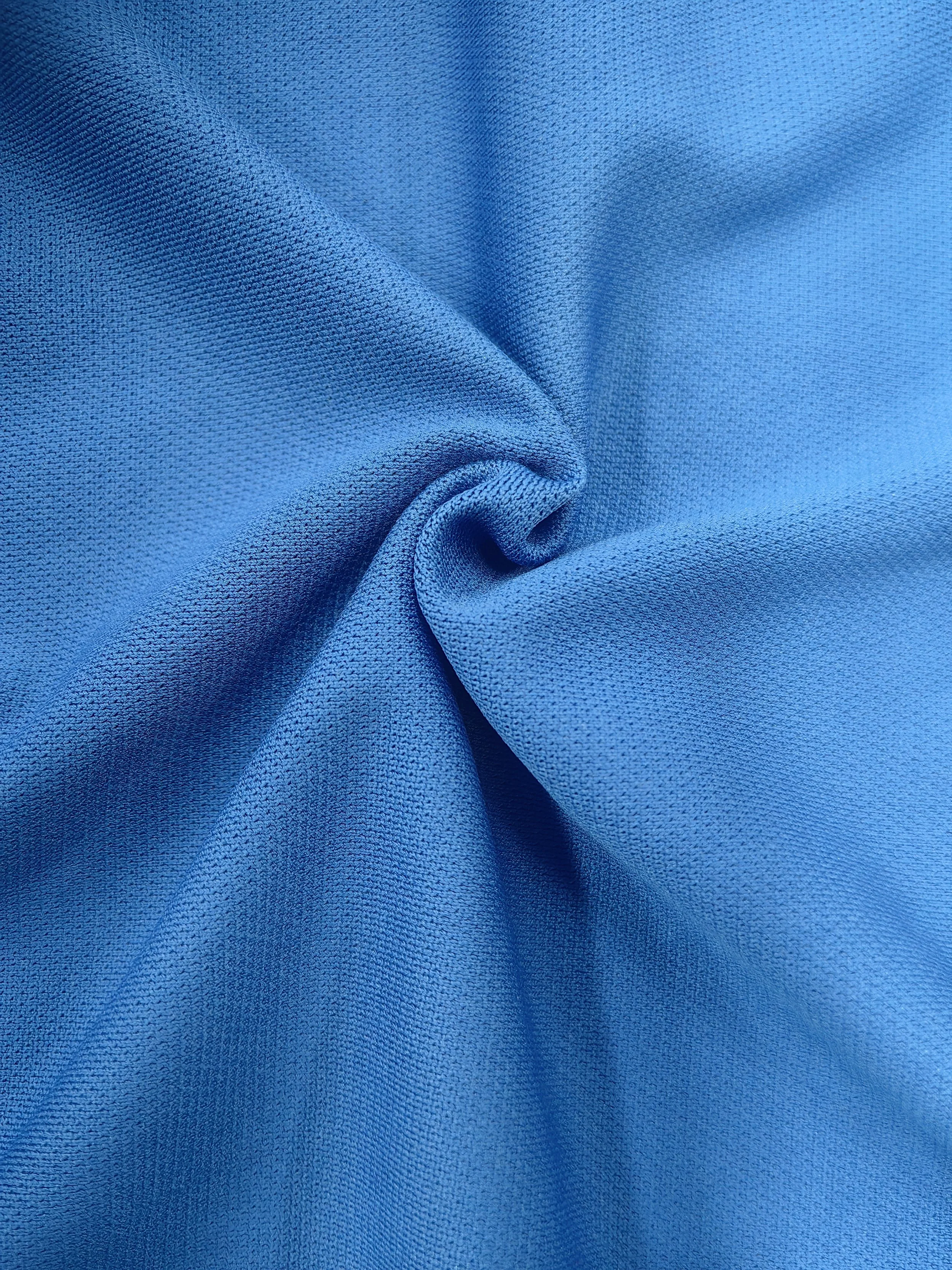 Close-up of blue fabric with textured, slightly wrinkled surface.