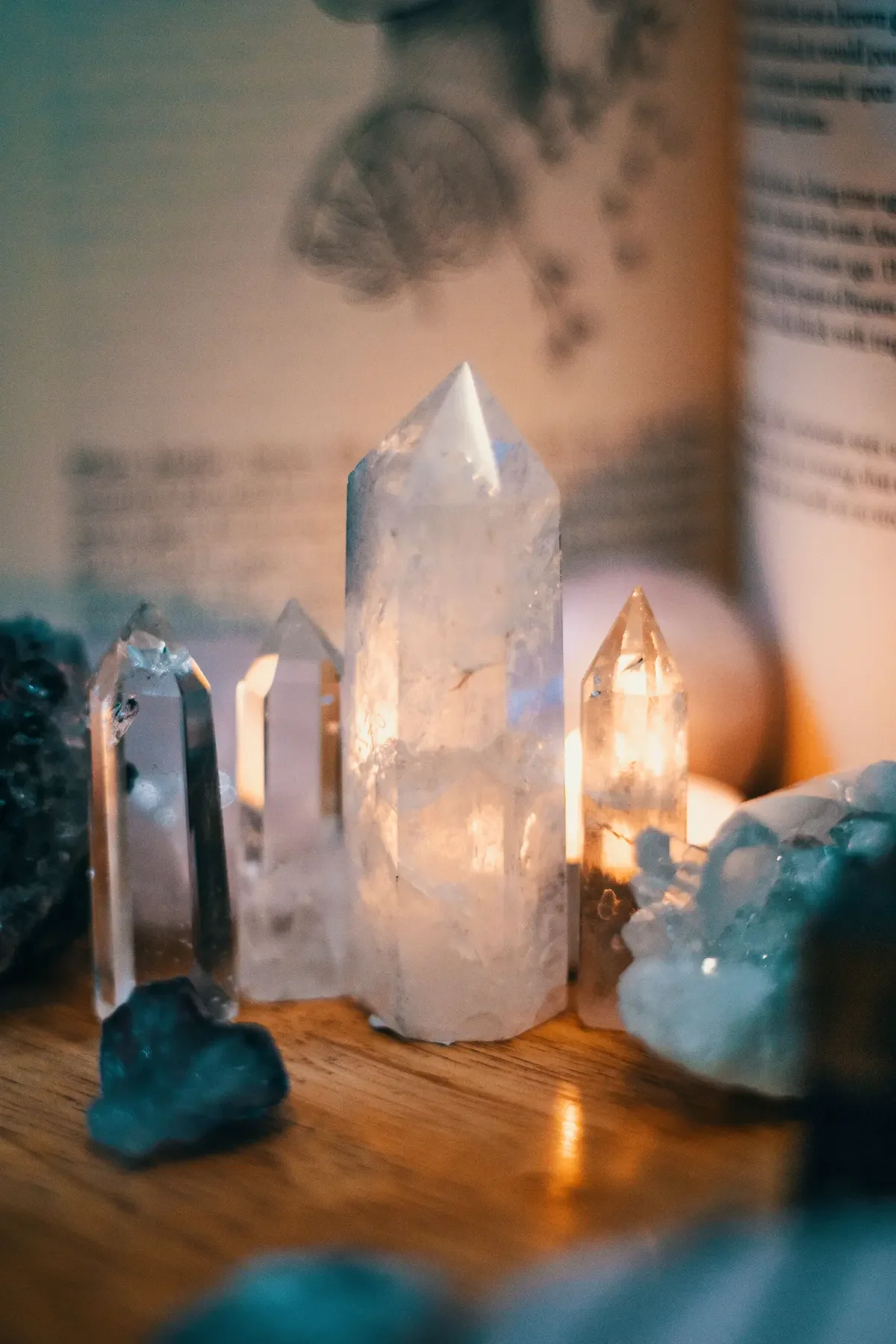 Five polished crystals in rose quartz, clear quartz, green aventurine, and amethyst arranged vertically