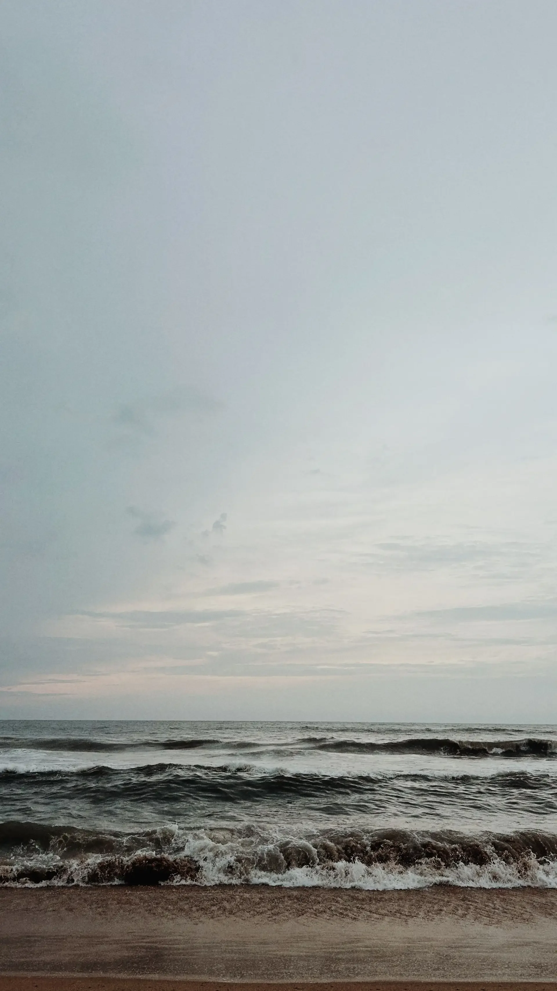 Waves at sunset crashing on the beach