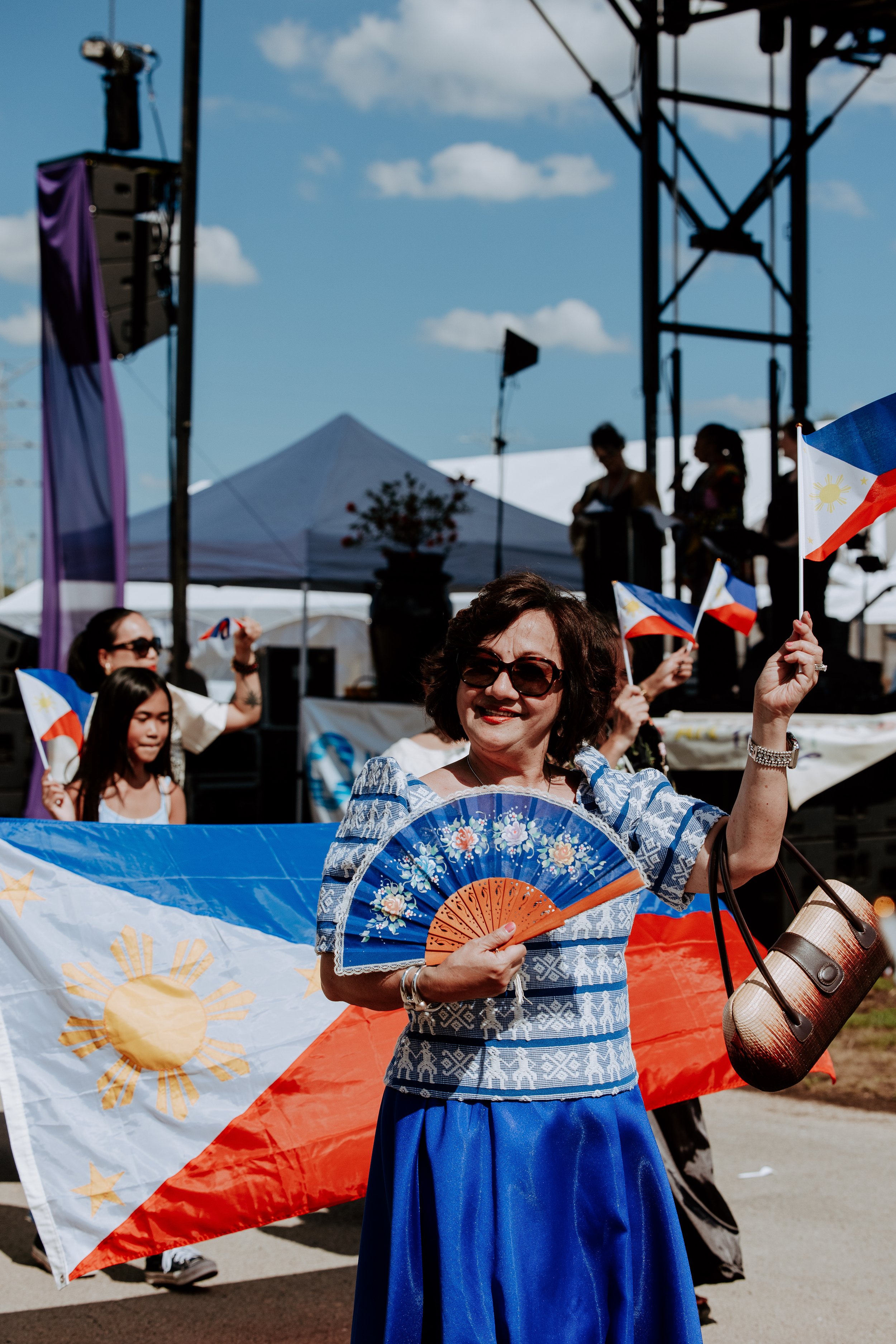 mrs dee with fan w philippino flag in background (V).jpg