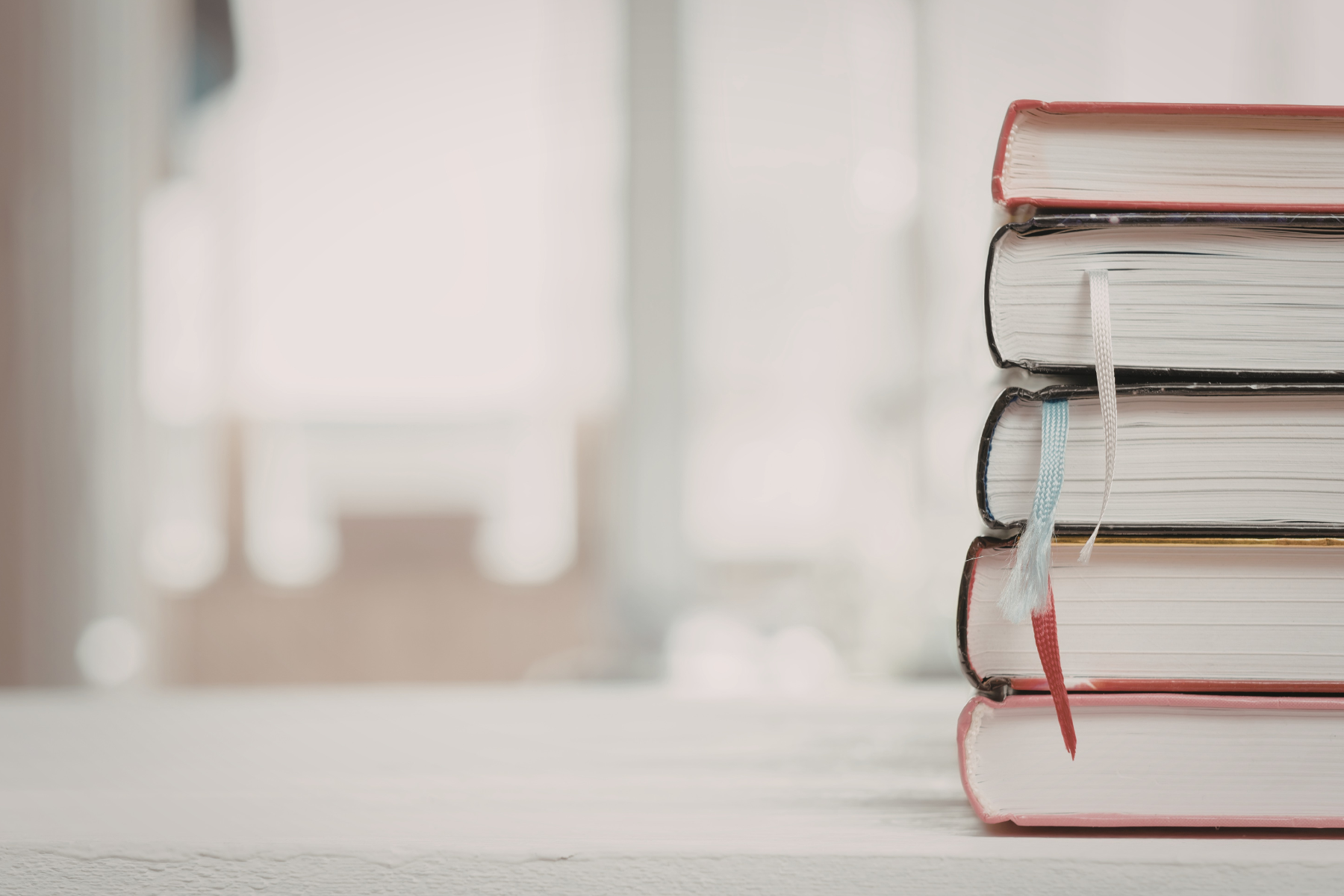 A stack of books with colored bookmarks.