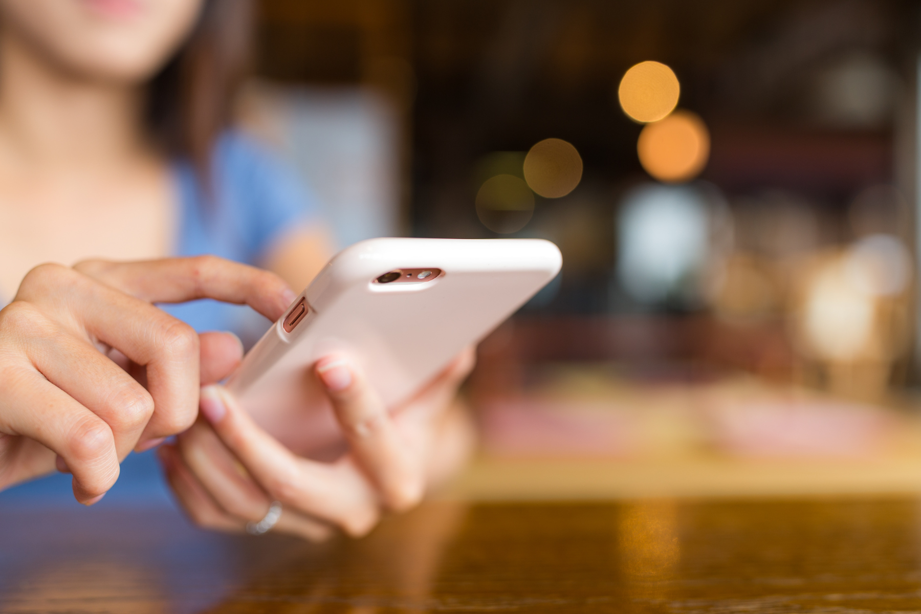 A woman sending a text message on her phone.