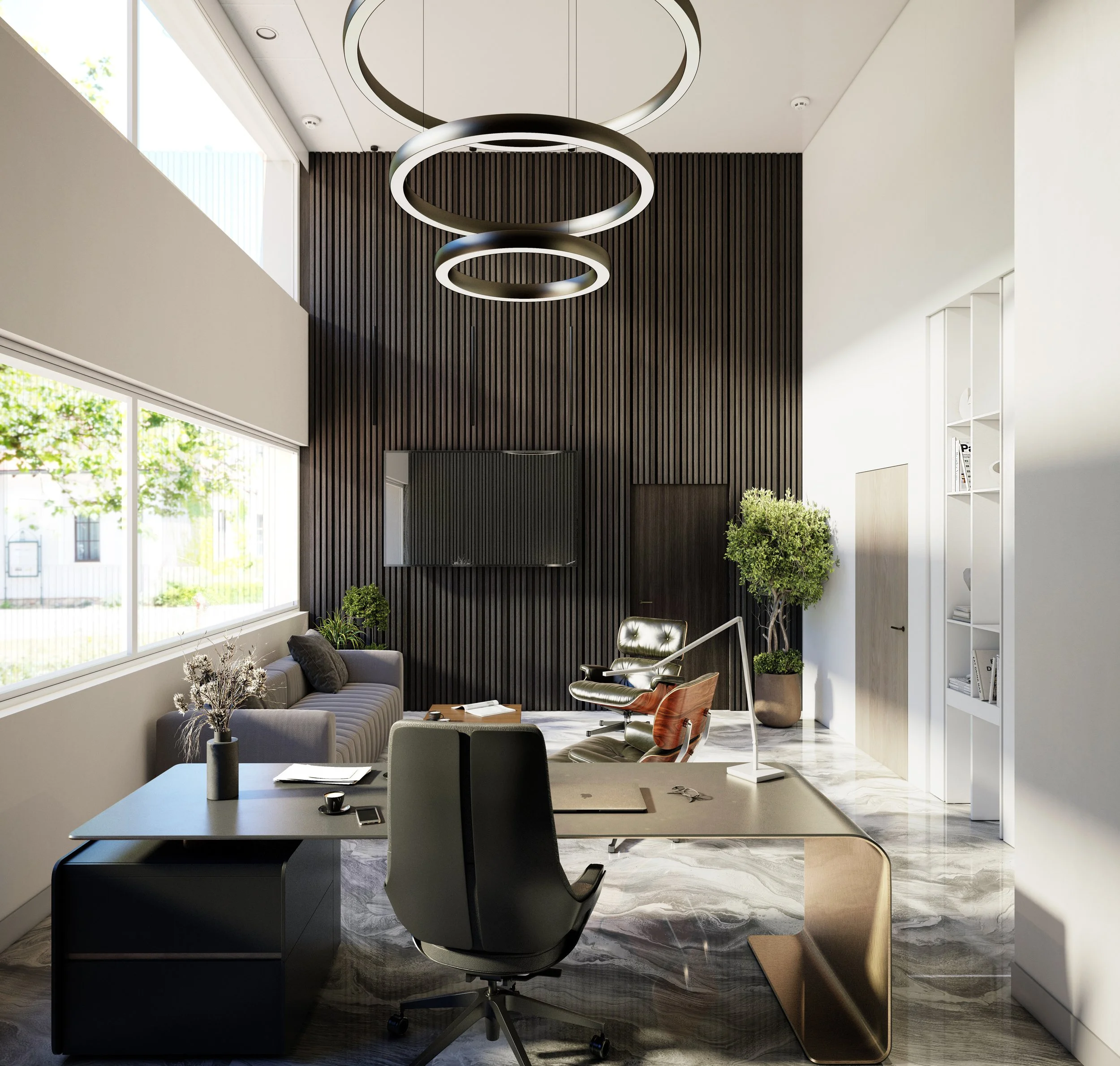 Modern office space with white walls, large windows, a black chair, a gray couch, plants, a dark wood-paneled wall, and a unique circular pendant light fixture hanging from the ceiling.