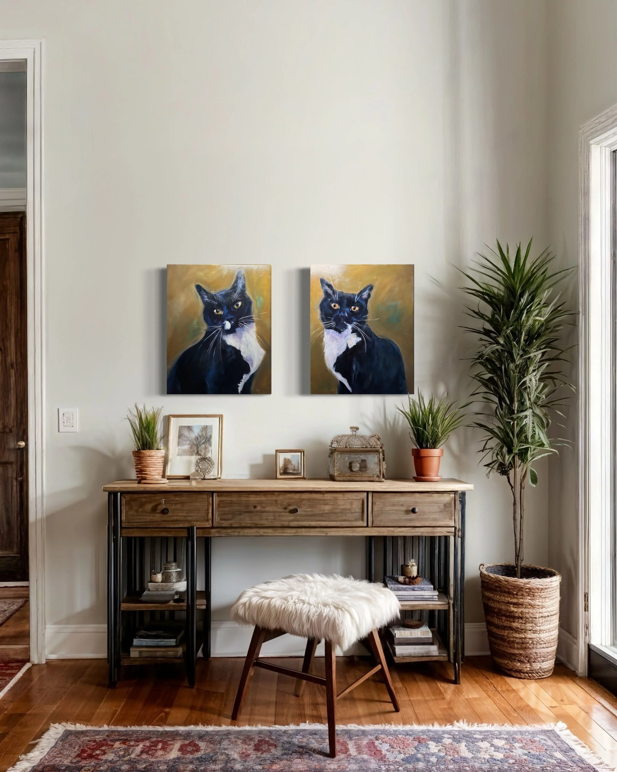 A room with a wooden desk, decorative items, and framed pictures on the wall. Two paintings of black cats are hung above the desk. A large potted plant is placed to the right of the desk, and a fluffy stool is in front. A patterned rug is on the wood