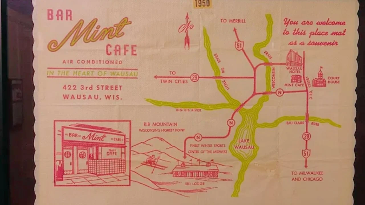 Vintage map and advertisement for the Mint Cafe in Wausau, Wisconsin, with directions, a sketch of the cafe, and nearby landmarks like Lake Wausau and Rib Mountain.