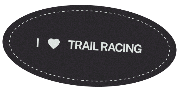 An oval sticker with a black background and white dashed border that reads "I ❤️ TRAIL RACING".