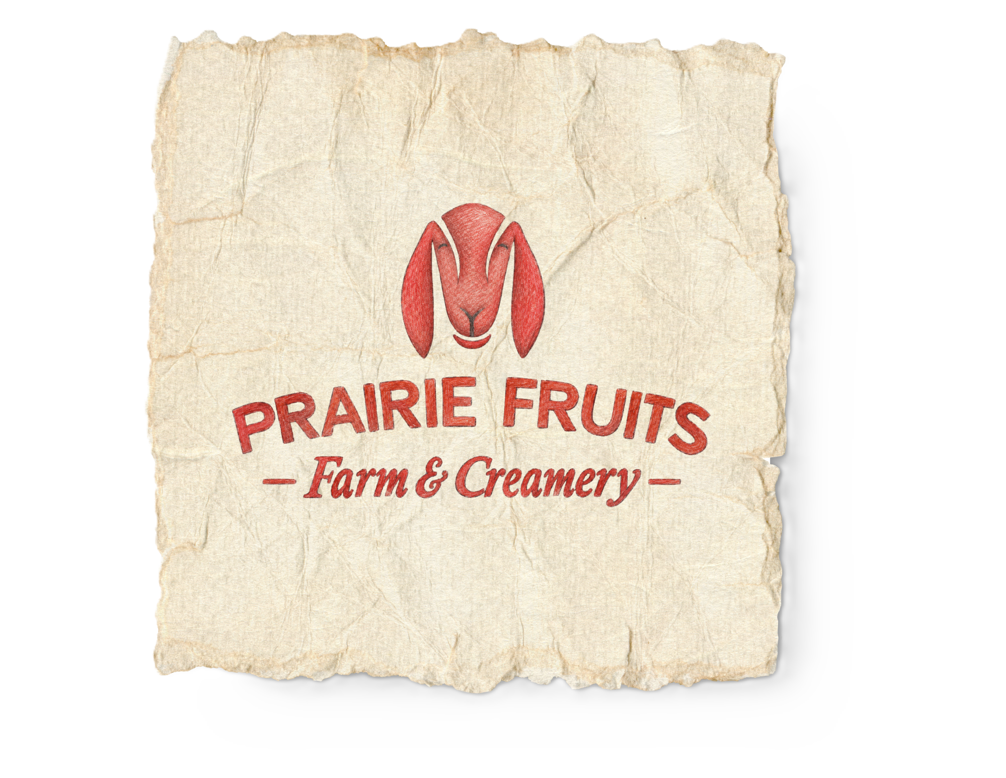 An old, crumpled paper bag with the Prairie Fruits Farm & Creamery logo, featuring a red stylized rabbit head and red text, on a white background with a subtle shadow.