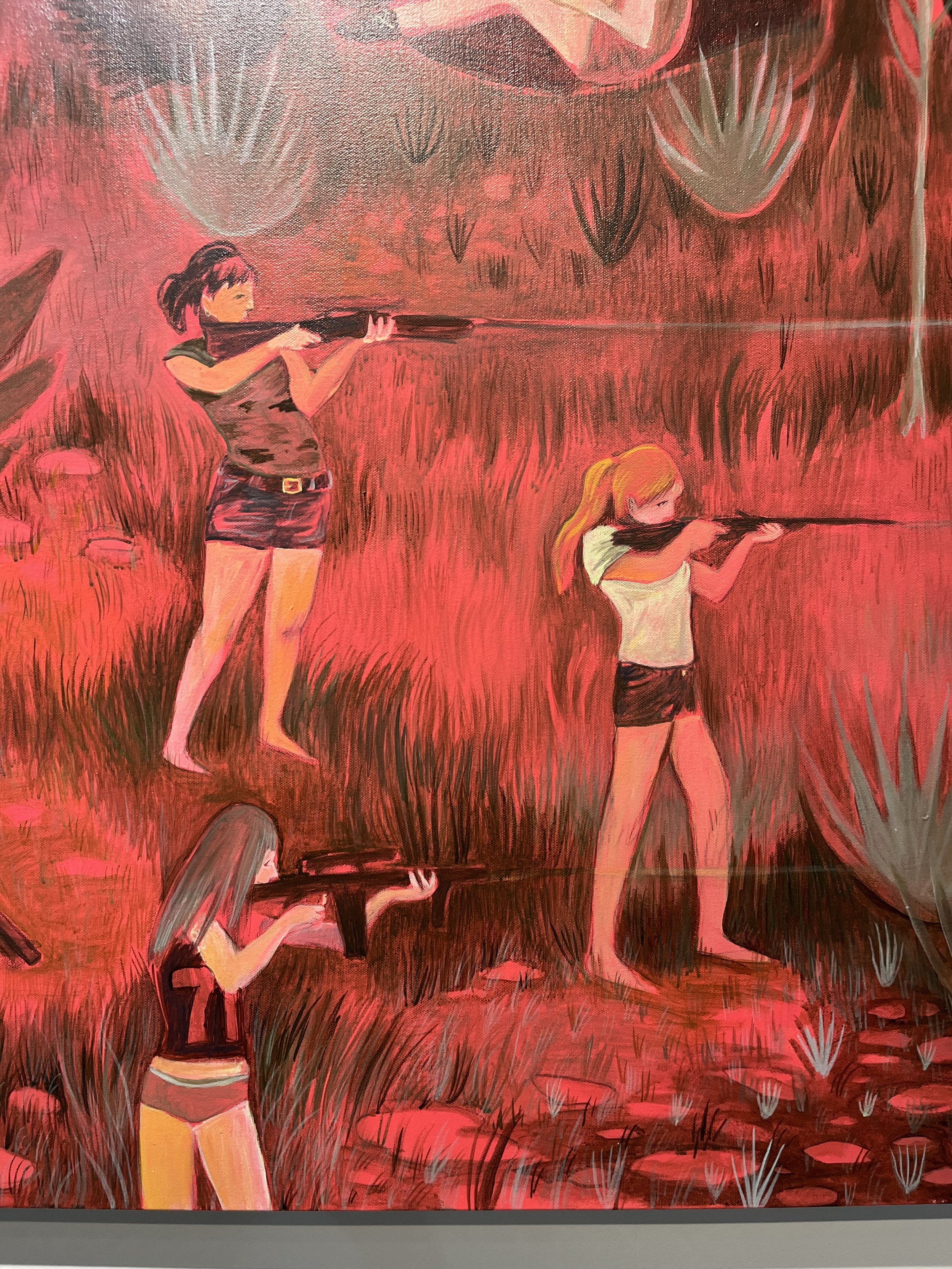 Painting of three girls with guns, in a red and black color palette. Two girls are aiming rifles and one girl is kneeling with a rifle. The background features a heart-shaped motif and abstract brush strokes.
