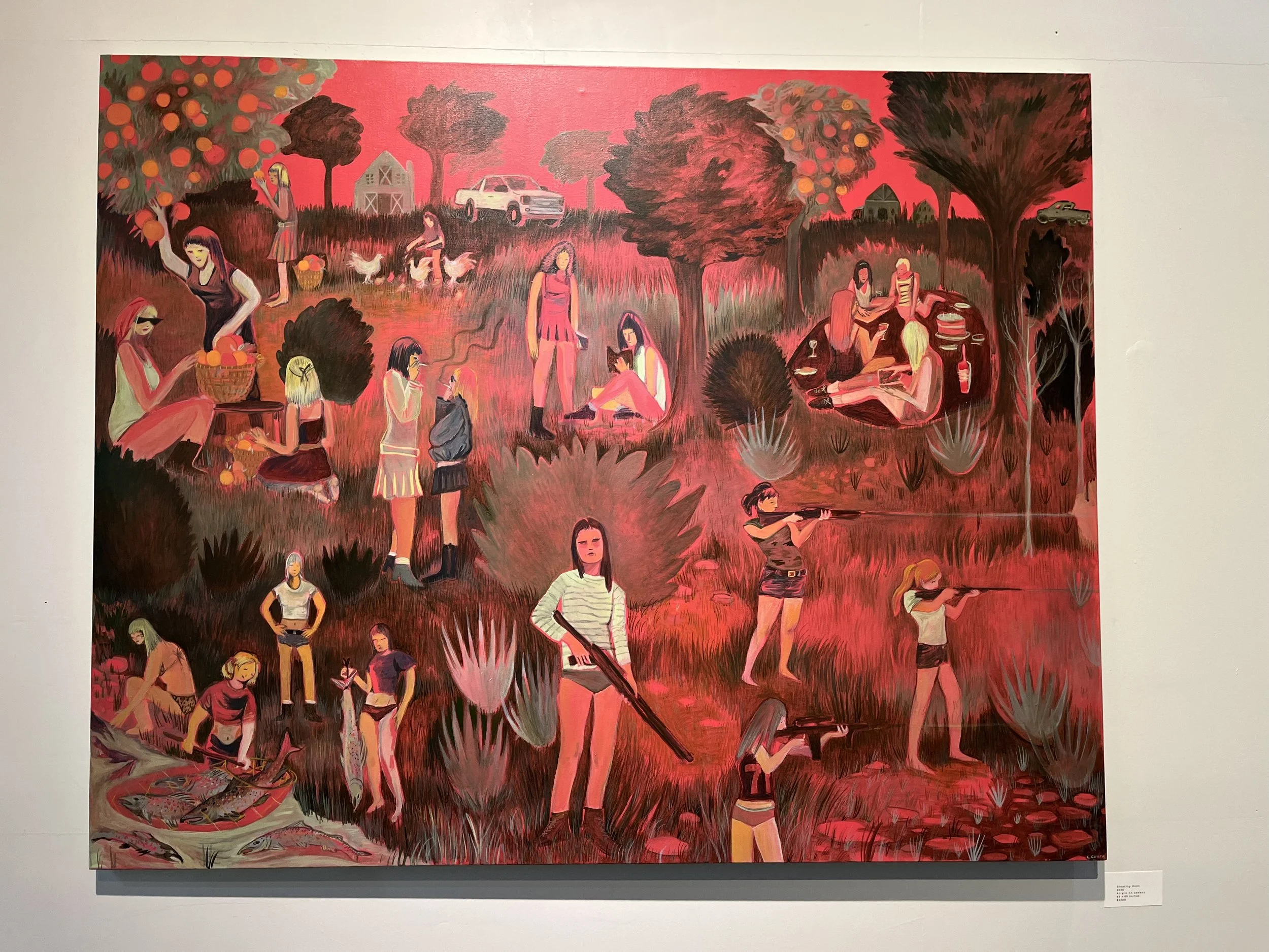 A vibrant painting depicting women gathering in a farm setting with trees, chickens, and a white truck. The scene includes women picking fruit from trees, sitting on the grass, and engaging in various activities, all set against a pinkish-red sky.