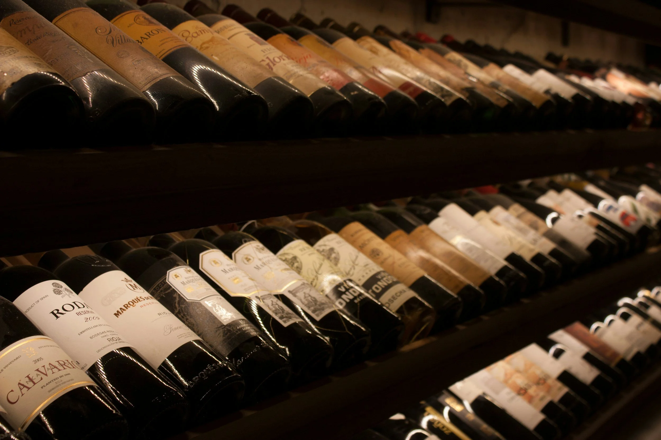 Multiple bottles of wine arranged on shelves, with labels visible.