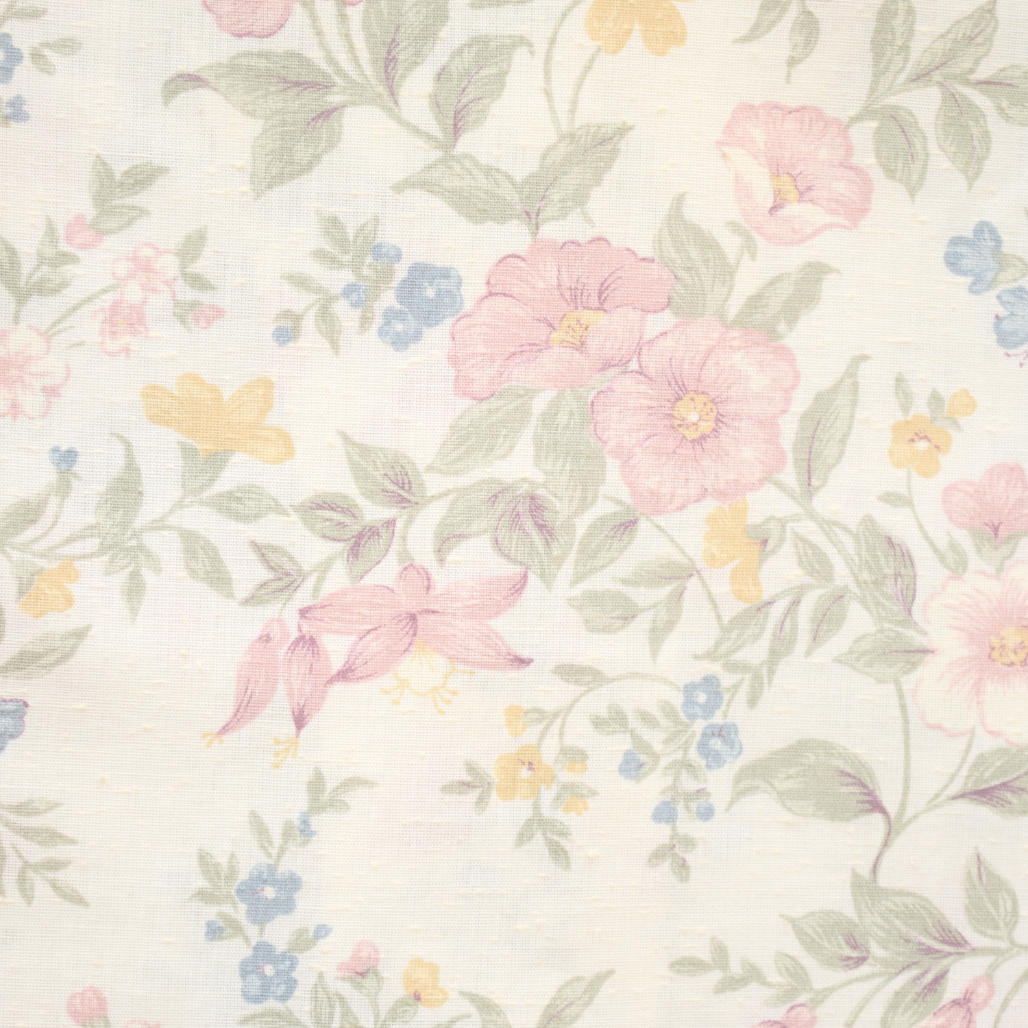 A fabric with a floral pattern featuring pink, yellow, and blue flowers with green leaves on a white background.