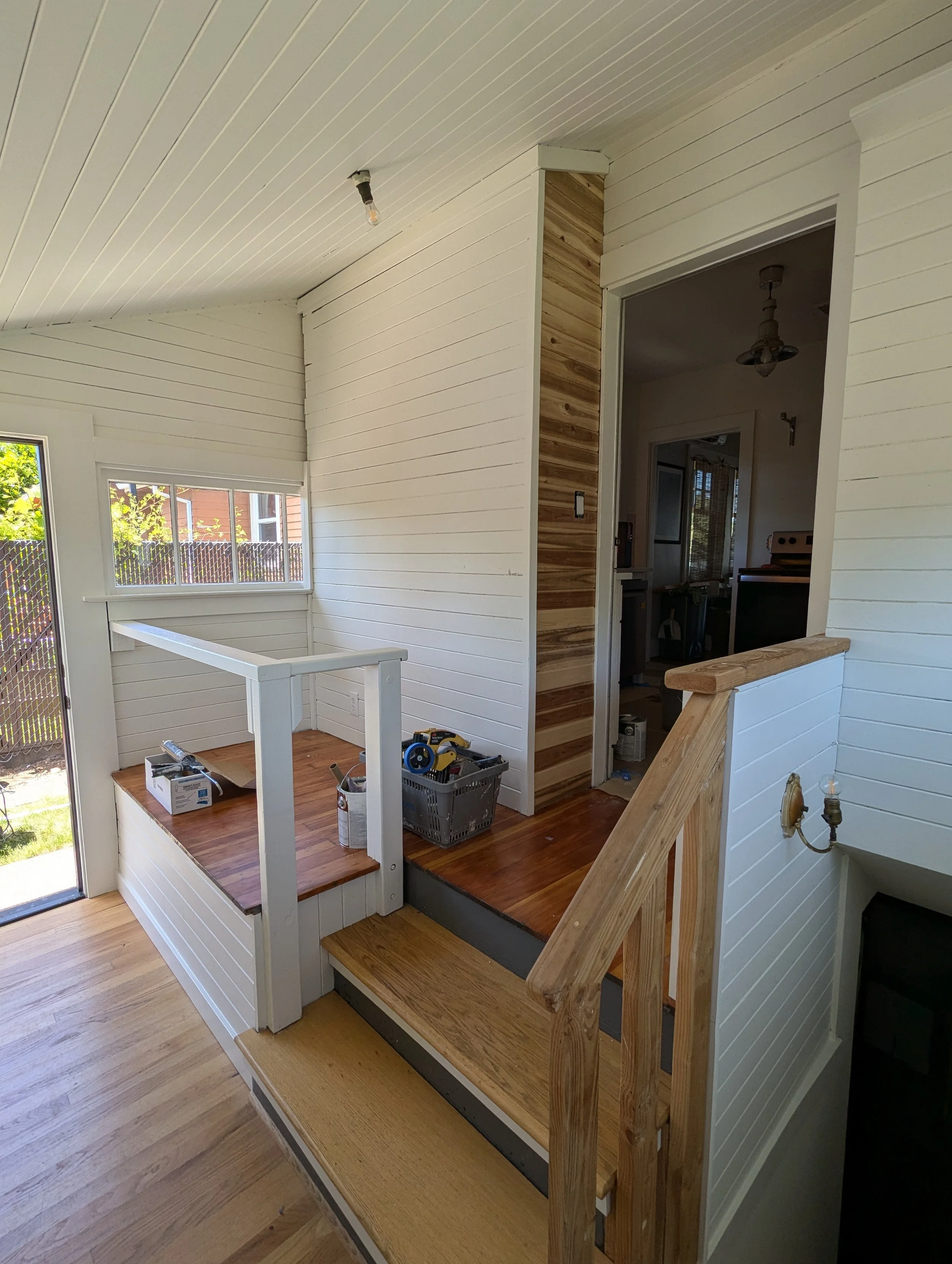 after image of same mudroom freshly painted and stained