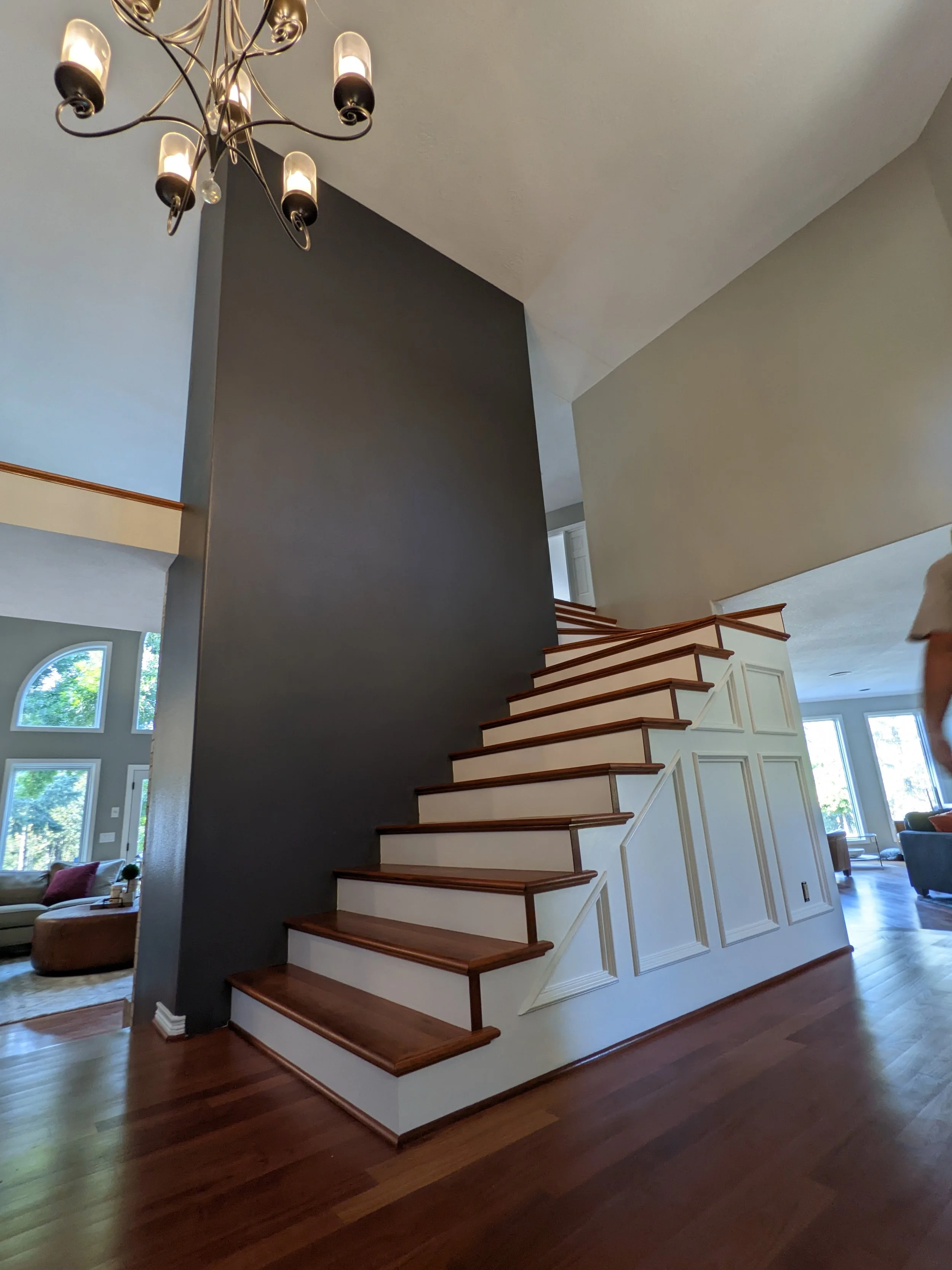 photo of a well painted stairwell and accent wall in the center of a large entry