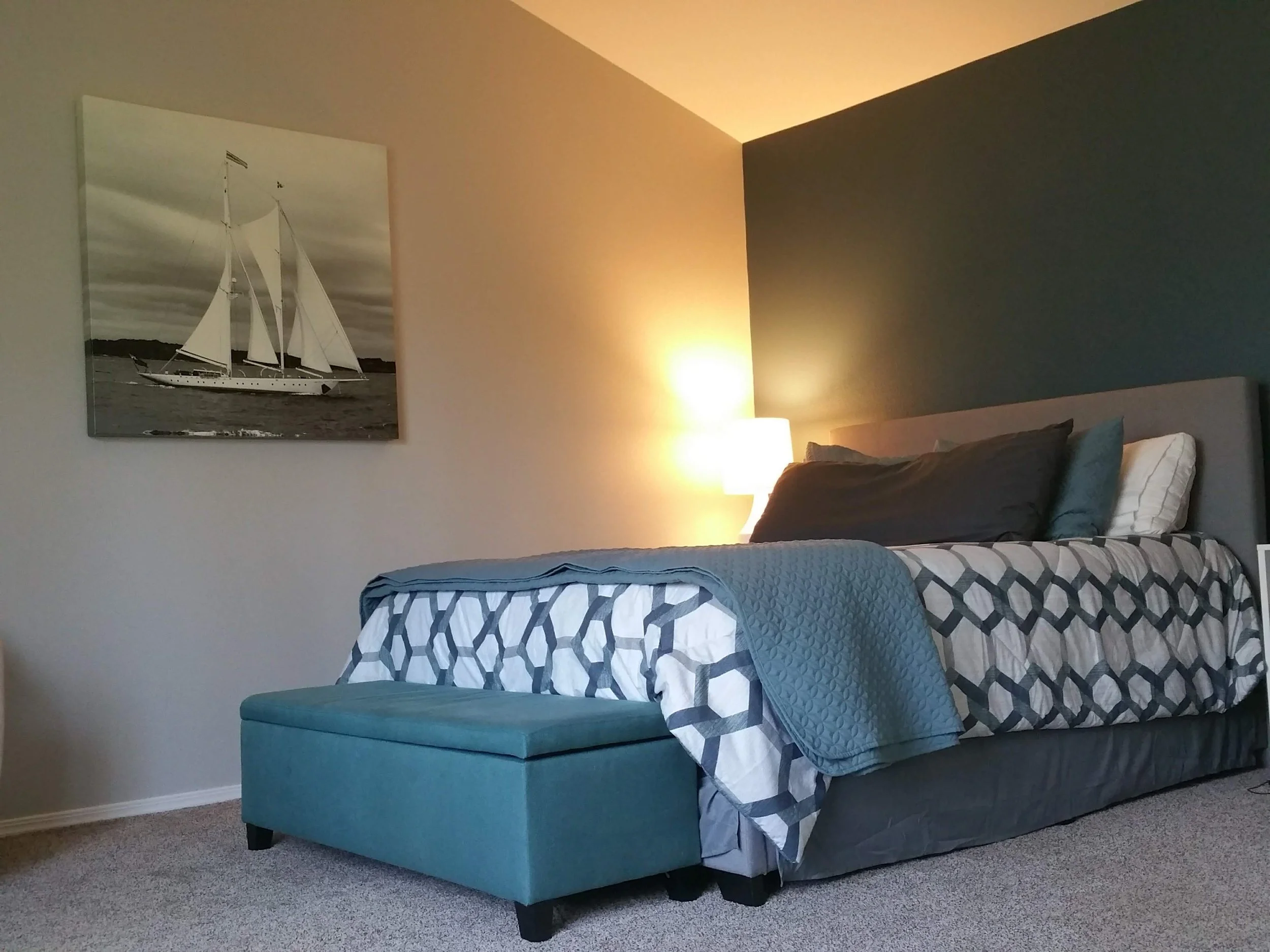 photo of a cozy bedroom with crisp painted lines and color coordinated accent wall