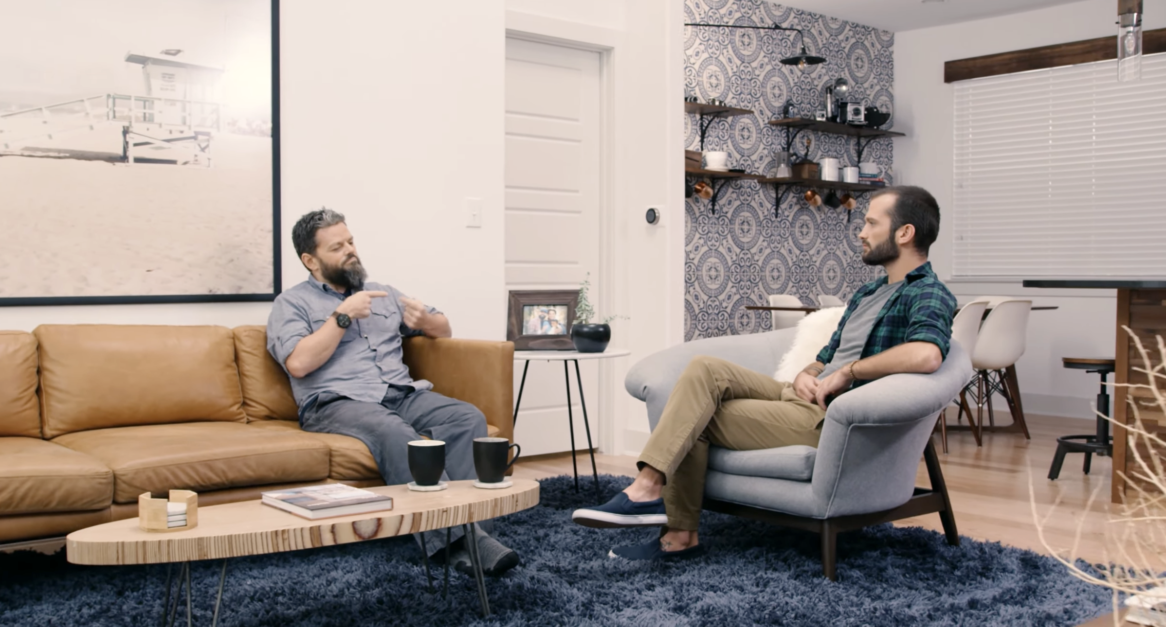 Video thumbnail for the 'National Deaf Therapy' commercial, showing two people signing in conversation in a modern living room