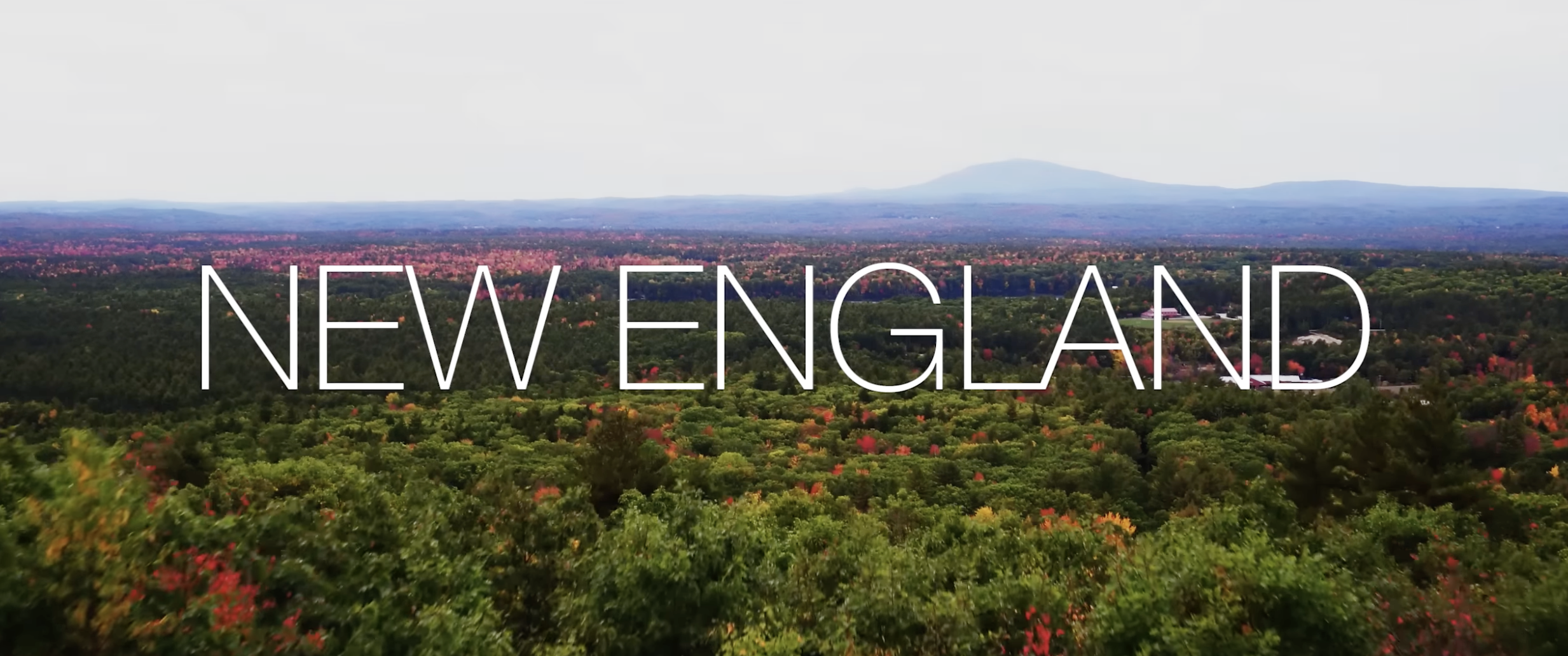 Video thumbnail for 'Our Deaf Community: New England,' an aerial view of a forested New England landscape with the title text overlaid