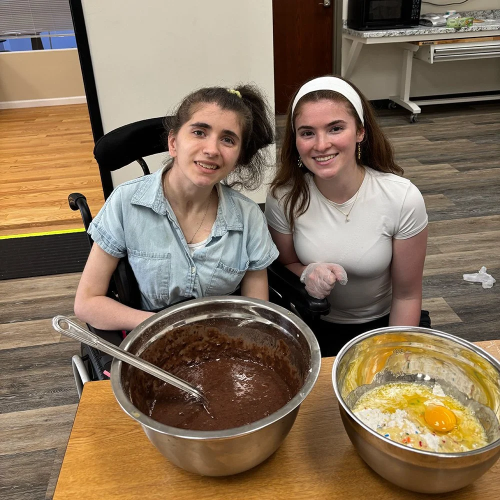 Two people enjoying a baking class