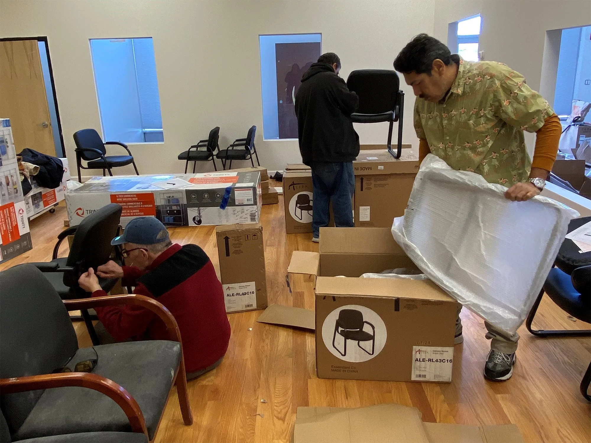 Individuals putting furniture together