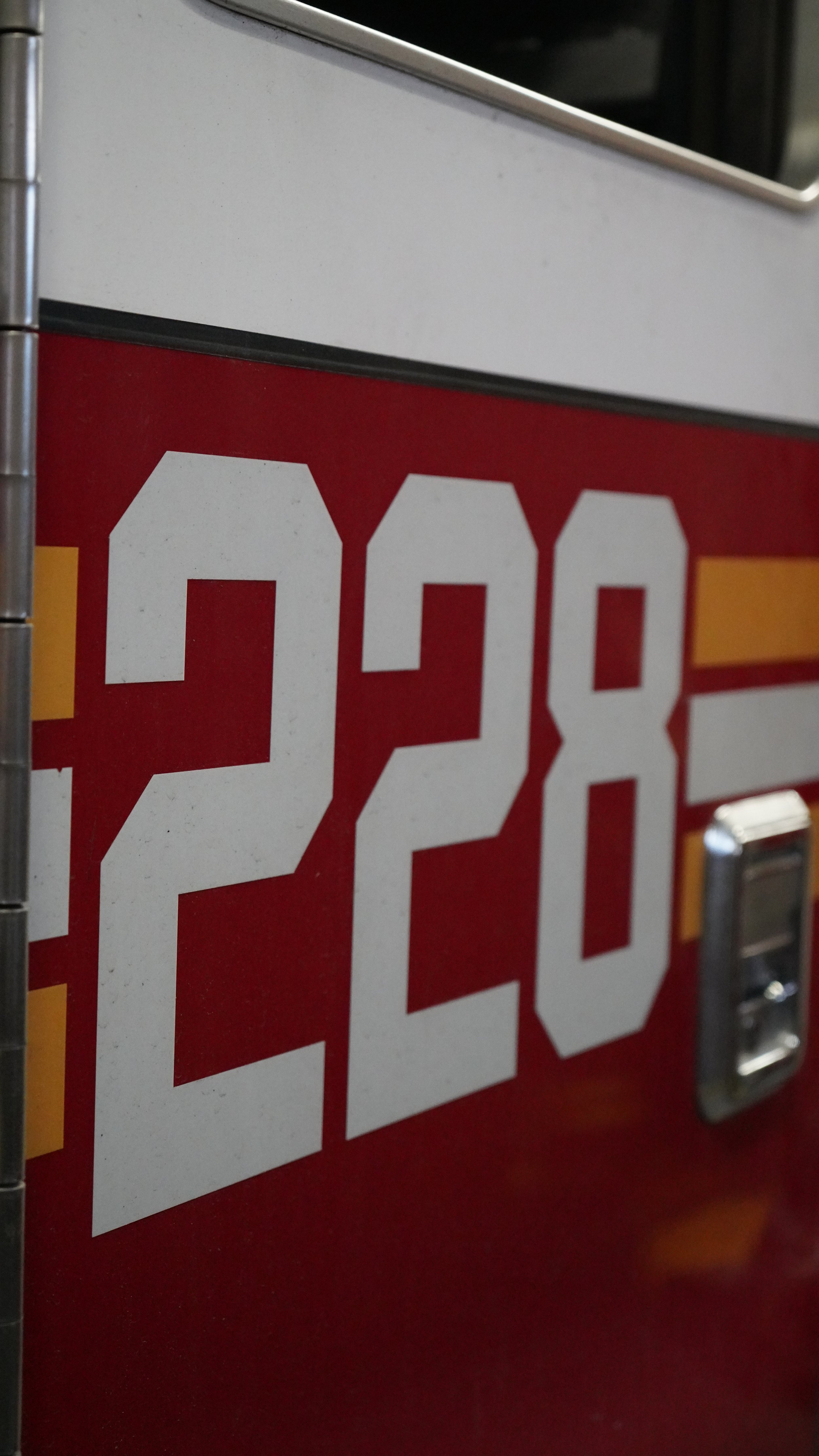 Close-up of a red and white digital price display showing the numbers 2.8.