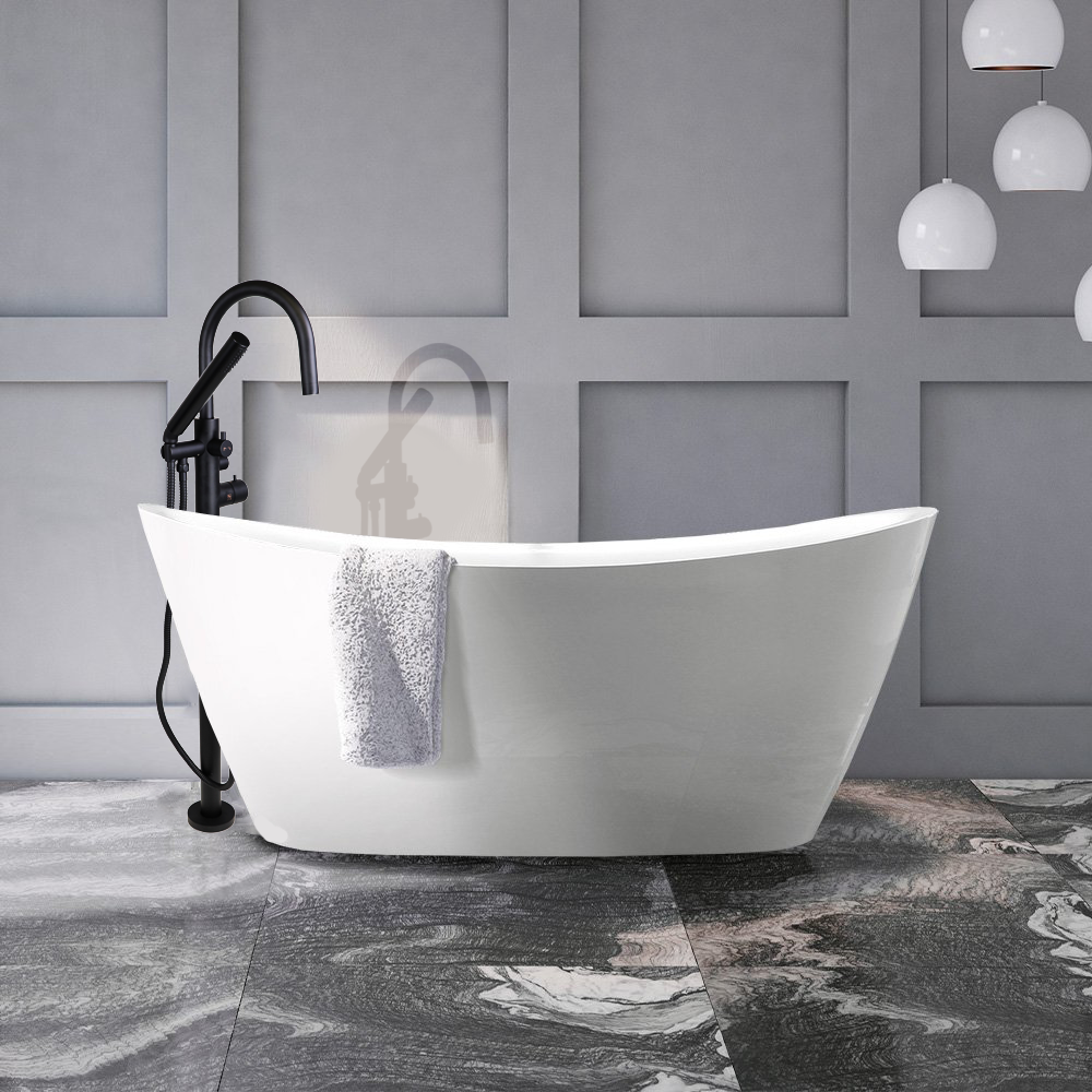 Modern white freestanding bathtub in a gray tiled bathroom with black fixtures and marble floor, with white hanging pendant lights.
