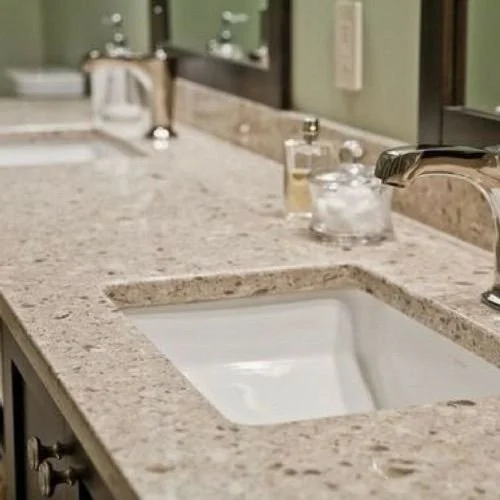 Bathroom countertop with a sink, soap dispenser, and a cup with a toothbrush.