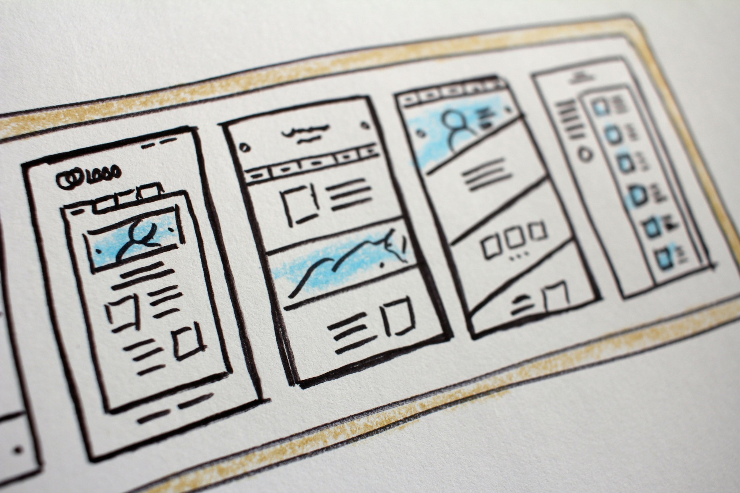 Close-up of a comic strip or illustrated graphic with black outlines, some sections filled with blue, on textured white paper.
