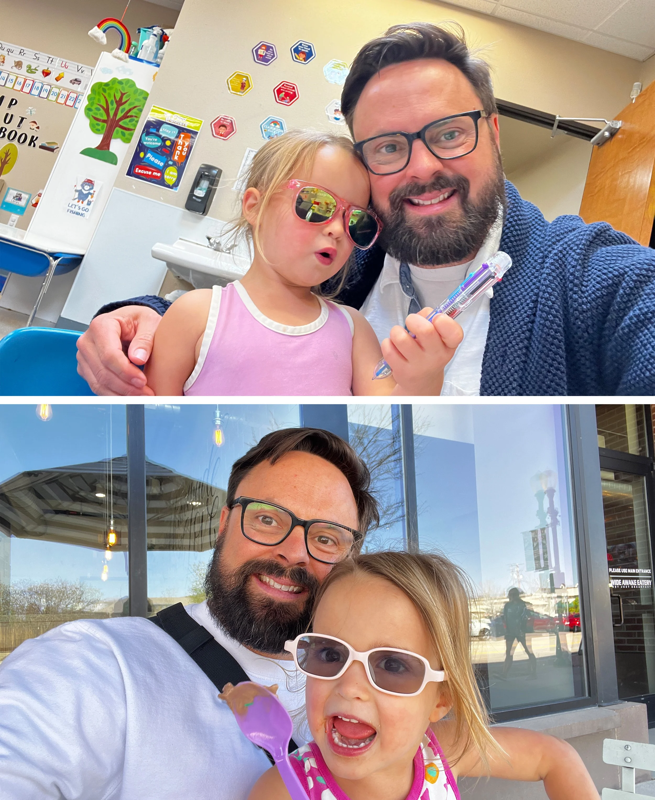 A man with glasses and a beard smiling, a young girl with glasses and blonde hair holding a purple spoon with ice cream, and another little girl in the background with glasses and blonde hair, outside in front of a store window during daytime.