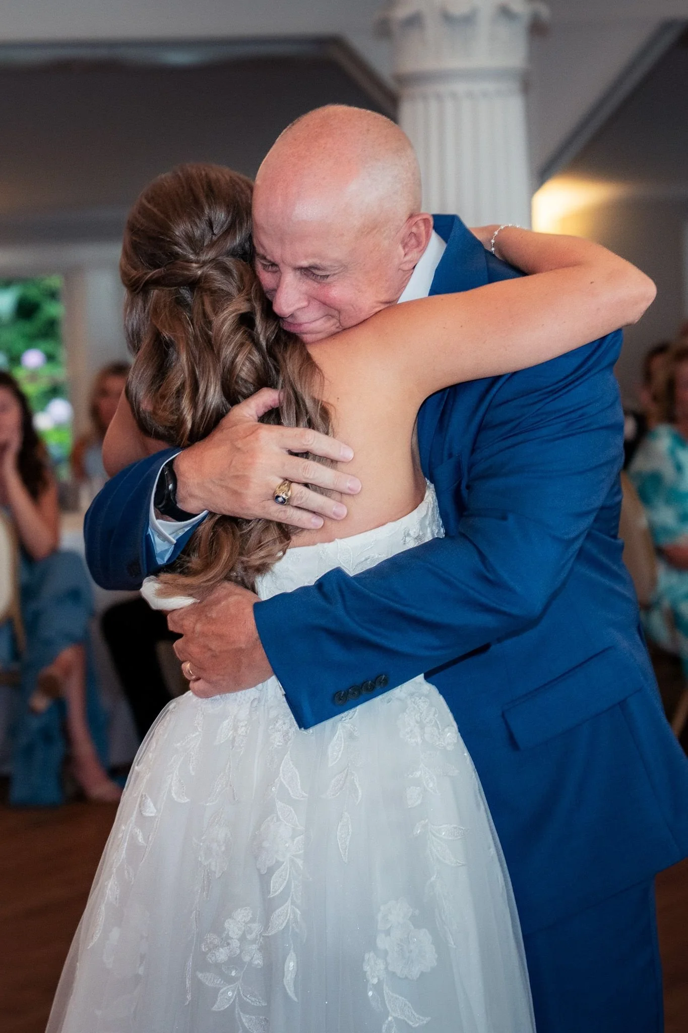 Bride embraces her father in an emotional wedding father daughter dance