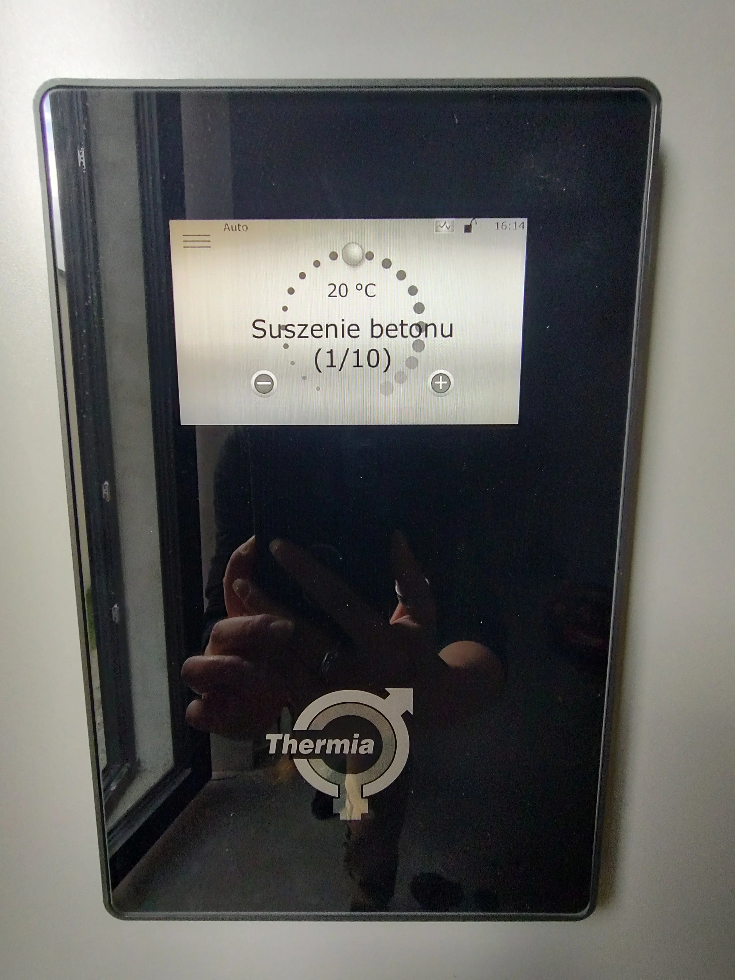 Close-up of a thermostatic control panel on a Thermia heating system, displaying a temperature of 20°C and an option for concrete drying.
